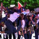 Colombia's flag bearer Caterine Ibarguen jumps for a photo during the opening ceremony of the Tokyo 2020 Olympic Games, at the Olympic Stadium, in Tokyo, on July 23, 2021. (Photo by Andrej ISAKOVIC / AFP)