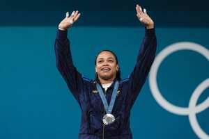 Silver medallist Colombia's Mari Leivis Sanchez celebrates on the podium after the women's -71kg weightlifting event during the Paris 2024 Olympic Games at the South Paris Arena in Paris, on August 9, 2024. (Photo by Dimitar DILKOFF / AFP)