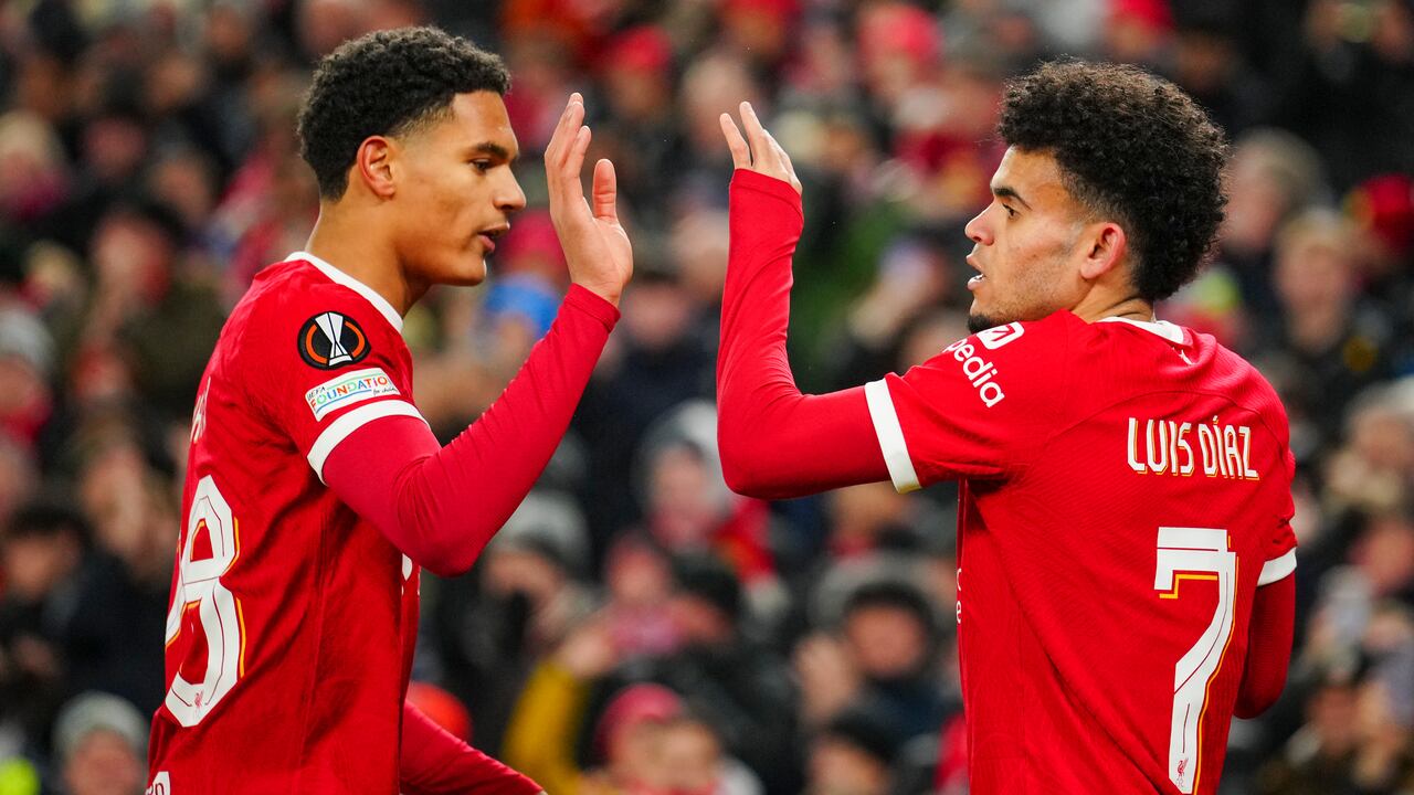 Liverpool's Luis Diaz, right, is congratulated by Cody Gakpo after scoring his side's opening goal during the Europa League Group E soccer match between Liverpool and LASK, at the Anfield stadium in Liverpool, England, Thursday, Nov. 30, 2023. (AP Photo/Jon Super)