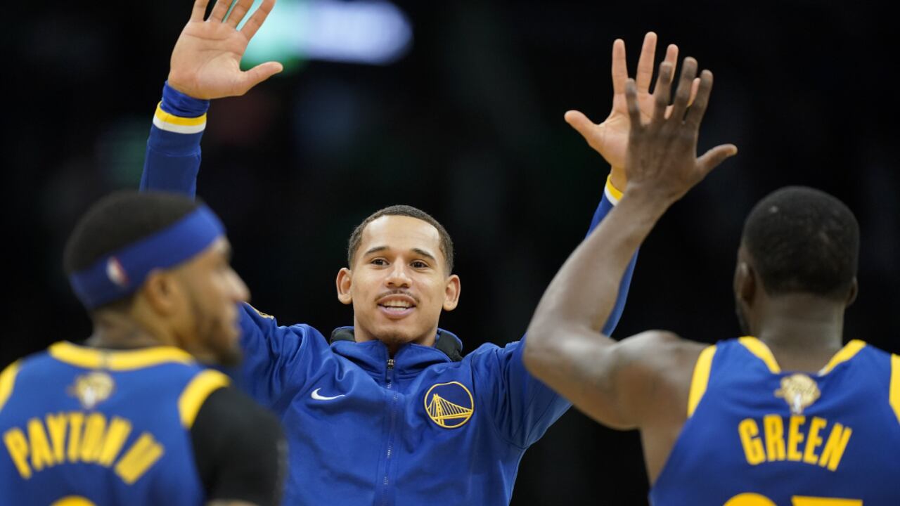 Golden State Warriors forward Juan Toscano-Anderson (95) high fives forward Draymond Green (23) and guard Gary Payton II (0) during the second quarter of Game 6 of basketball's NBA Finals against the Boston Celtics, Thursday, June 16, 2022, in Boston. (AP/Steven Senne)