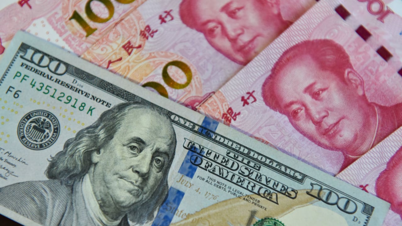 CHINA - 2023/08/29: In this photo illustration, a $100 bill and some 100 yuan are shown together. (Photo Illustration by Sheldon Cooper/SOPA Images/LightRocket via Getty Images)