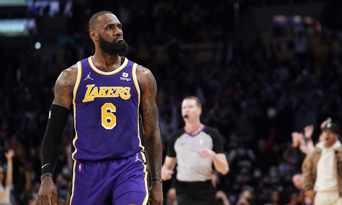 Los Angeles Lakers forward LeBron James reacts toward Aaron Donald of the Los Angeles Rams, who was sitting court side, after scoring during the second half of an NBA basketball game against the Utah Jazz Wednesday, Feb. 16, 2022, in Los Angeles. The Lakers won 106-101. (AP/Mark J. Terrill)