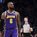 Los Angeles Lakers forward LeBron James reacts toward Aaron Donald of the Los Angeles Rams, who was sitting court side, after scoring during the second half of an NBA basketball game against the Utah Jazz Wednesday, Feb. 16, 2022, in Los Angeles. The Lakers won 106-101. (AP Photo/Mark J. Terrill)