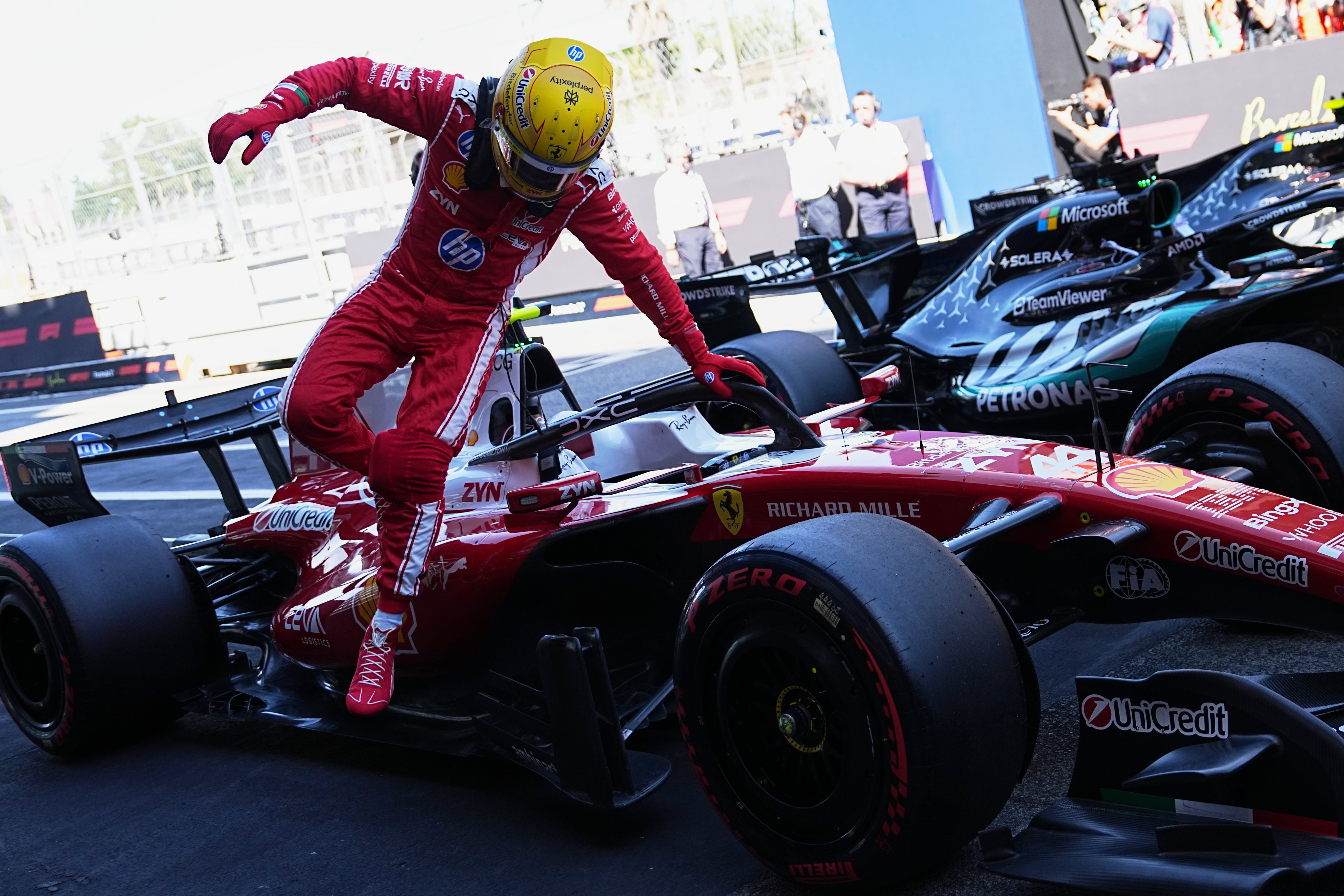 Ferrari driver Lewis Hamilton of Britain jumps from his car after qualifying session for the Spain F1 Grand Prix at the Barcelona Catalunya racetrack in Montmelo, near Barcelona, Spain, Saturday, June 13, 2026. (AP Photo/Fatima Shbair)