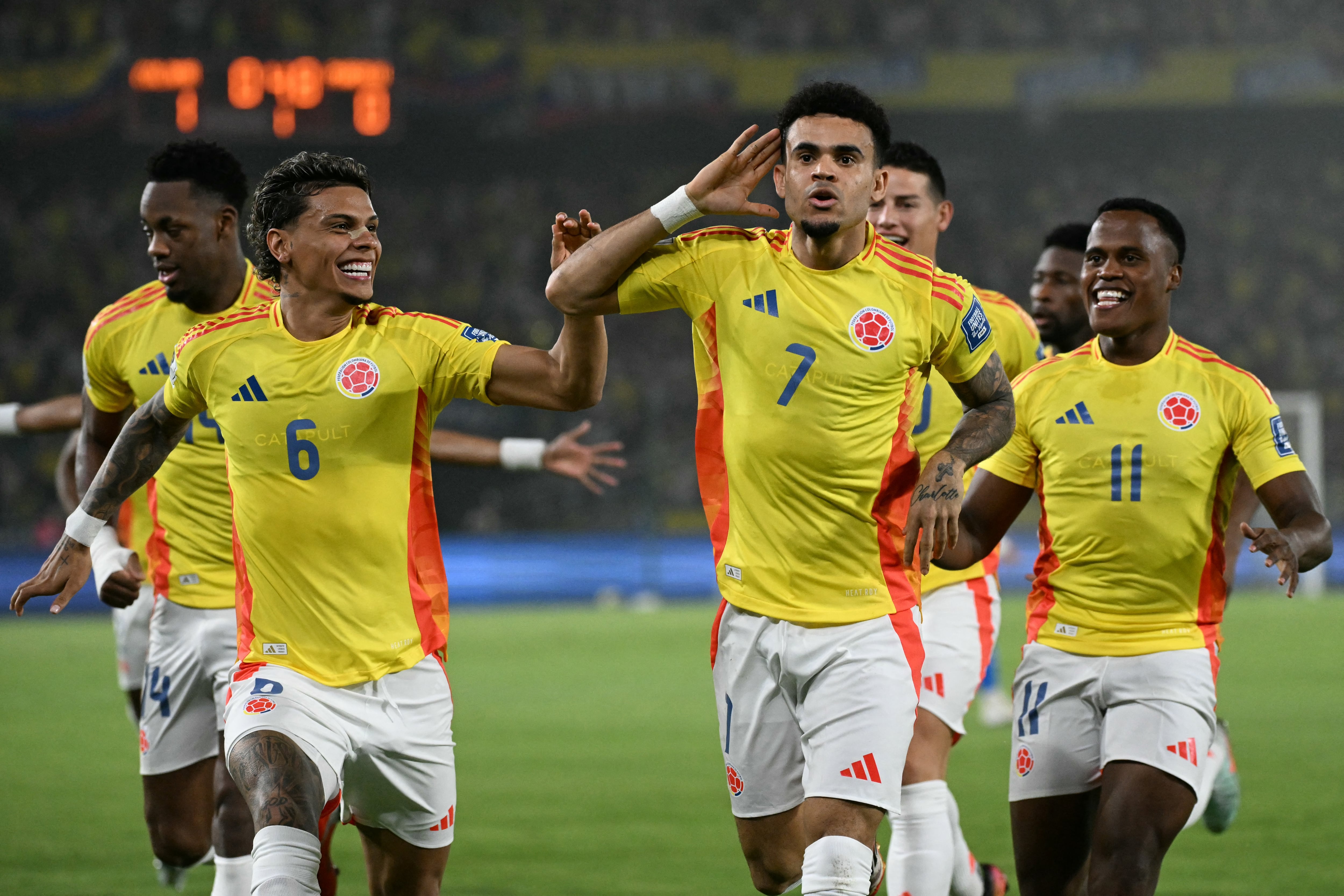 Colombia's forward #07 Luis Diaz (2nd-R) celebrates with teammates midfielder #06 Richard Rios and forward #11 Jhon Arias after scoring his team first goal during the 2026 FIFA World Cup South American qualifiers football match between Colombia and Paraguay at the Metropolitano Roberto Melendez stadium in Barranquilla, Colombia, on March 25, 2025. (Photo by Luis ACOSTA / AFP)