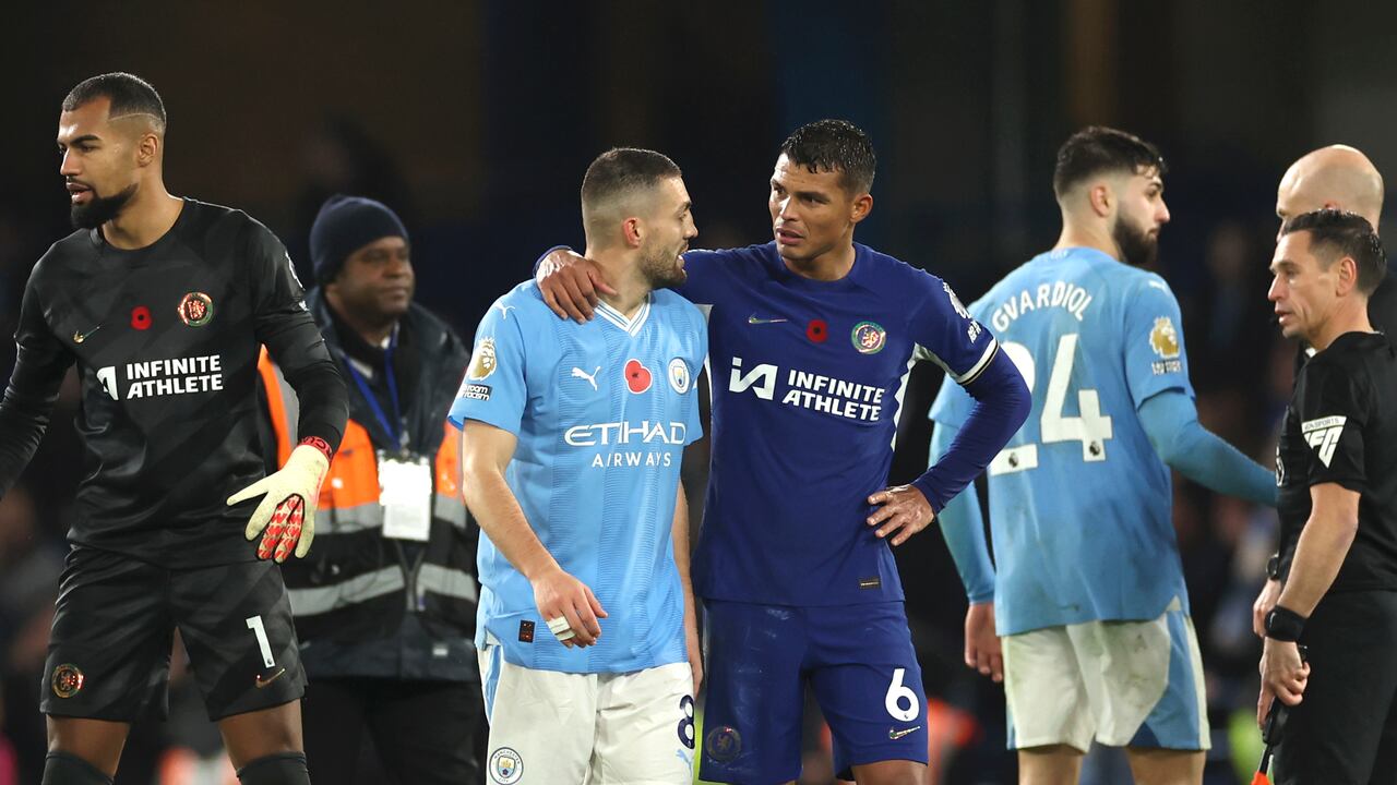 Chelsea's Thiago Silva leaves the field with Manchester City's Mateo Kovacic at the end of the English Premier League soccer match between Chelsea and Manchester City at Stamford Bridge stadium in London, Sunday, Nov. 12, 2023. (AP Photo/Ian Walton)