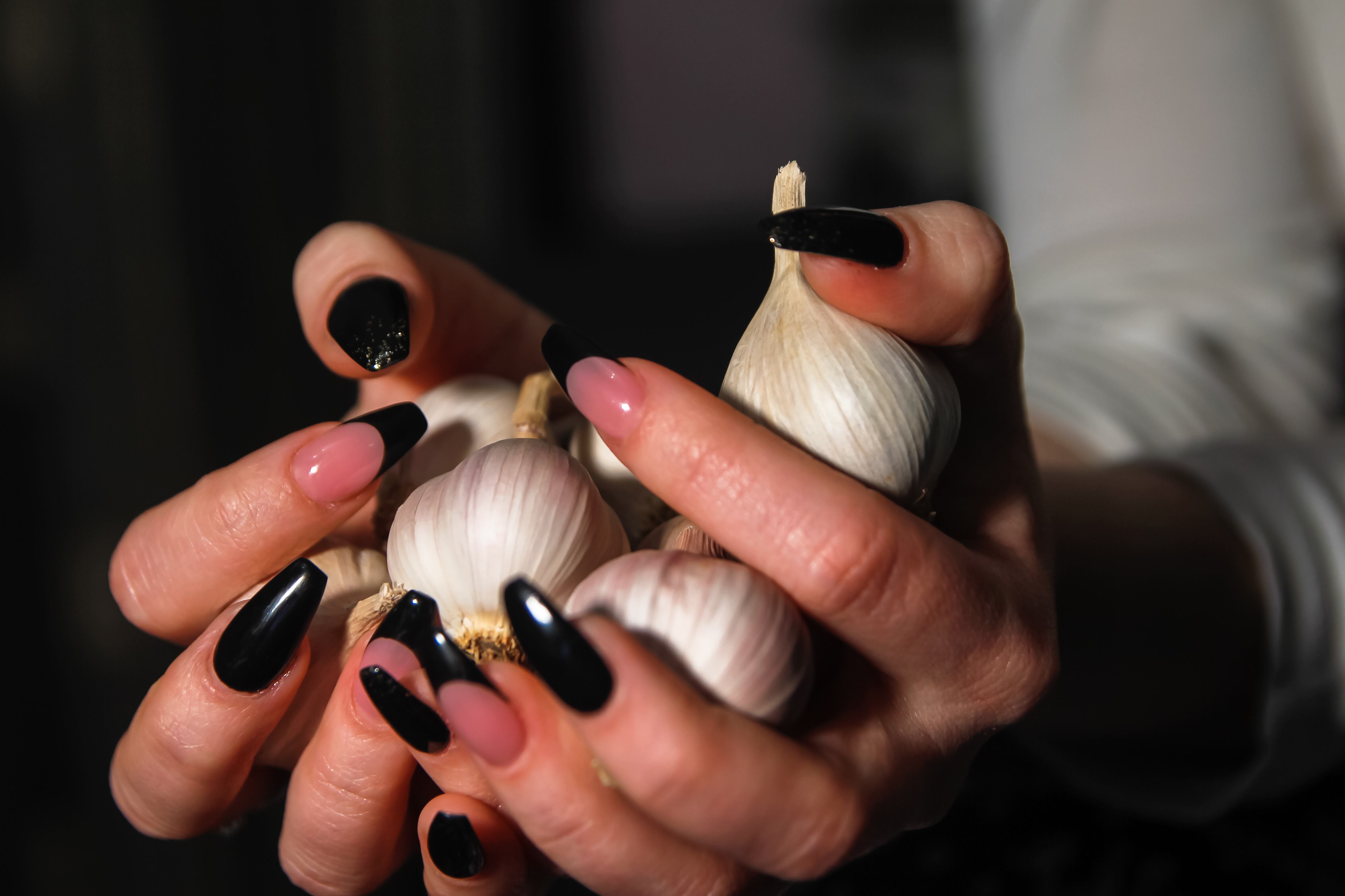 Women's hands holding garlic