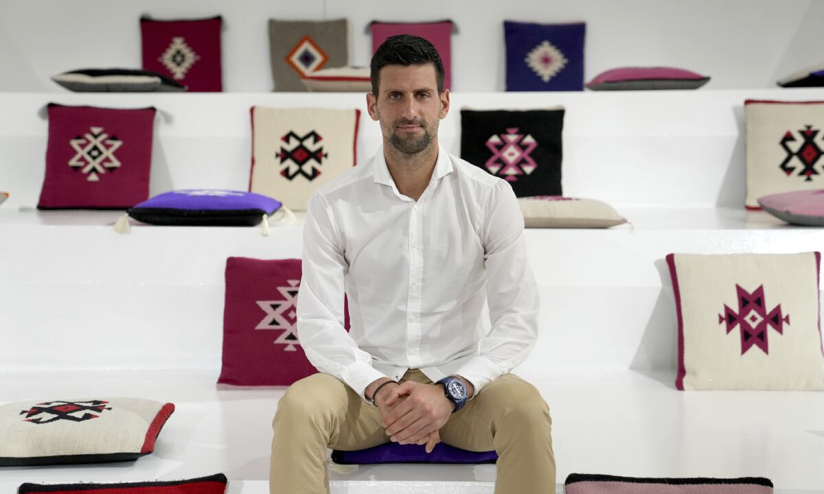 Serbian tennis star Novak Djokovic poses for a photo after his presentation of the Novak Djokovic foundation in the Serbia pavilion at Dubai Expo 2020, in Dubai, United Arab Emirates, Thursday, Feb. 17, 2022. Djokovic on Thursday received a warm welcome in Dubai, where he visited the world's fair following the global drama around his decision to remain unvaccinated. (AP/Ebrahim Noroozi)