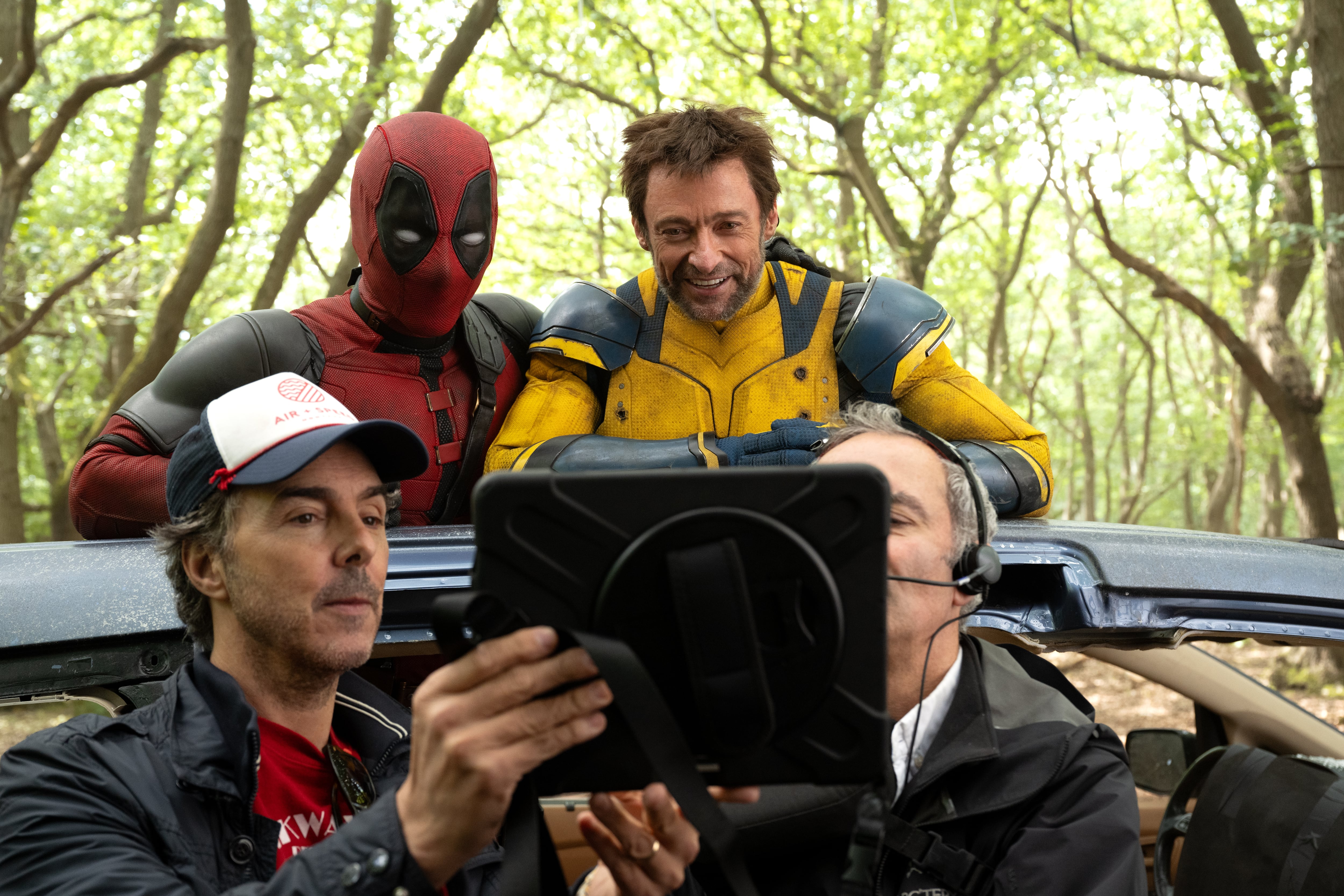 (L-R): Director Shawn Levy, Ryan Reynolds, and Hugh Jackman on the set of Marvel Studios' DEADPOOL & WOLVERINE. Photo by Jay Maidment. © 2024 20th Century Studios / © and ™ 2024 MARVEL.