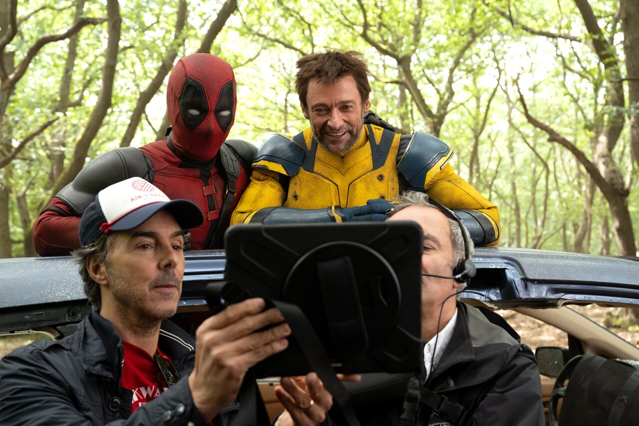 (L-R): Director Shawn Levy, Ryan Reynolds, and Hugh Jackman on the set of Marvel Studios' DEADPOOL & WOLVERINE. Photo by Jay Maidment. © 2024 20th Century Studios / © and ™ 2024 MARVEL.