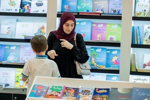 SHARJAH, UAE - NOVEMBER 2: People visit a publisher stand during the Sharjah International Book Fair at Sharjah Expo Center in Sharjah, United Arab Emirates on November 2, 2023. (Photo by Waleed Zein/Anadolu via Getty Images)