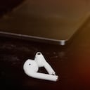 Close up of a laptop keyboard with black background and white AirPods in Donostia-San Sebastian, PV, Spain