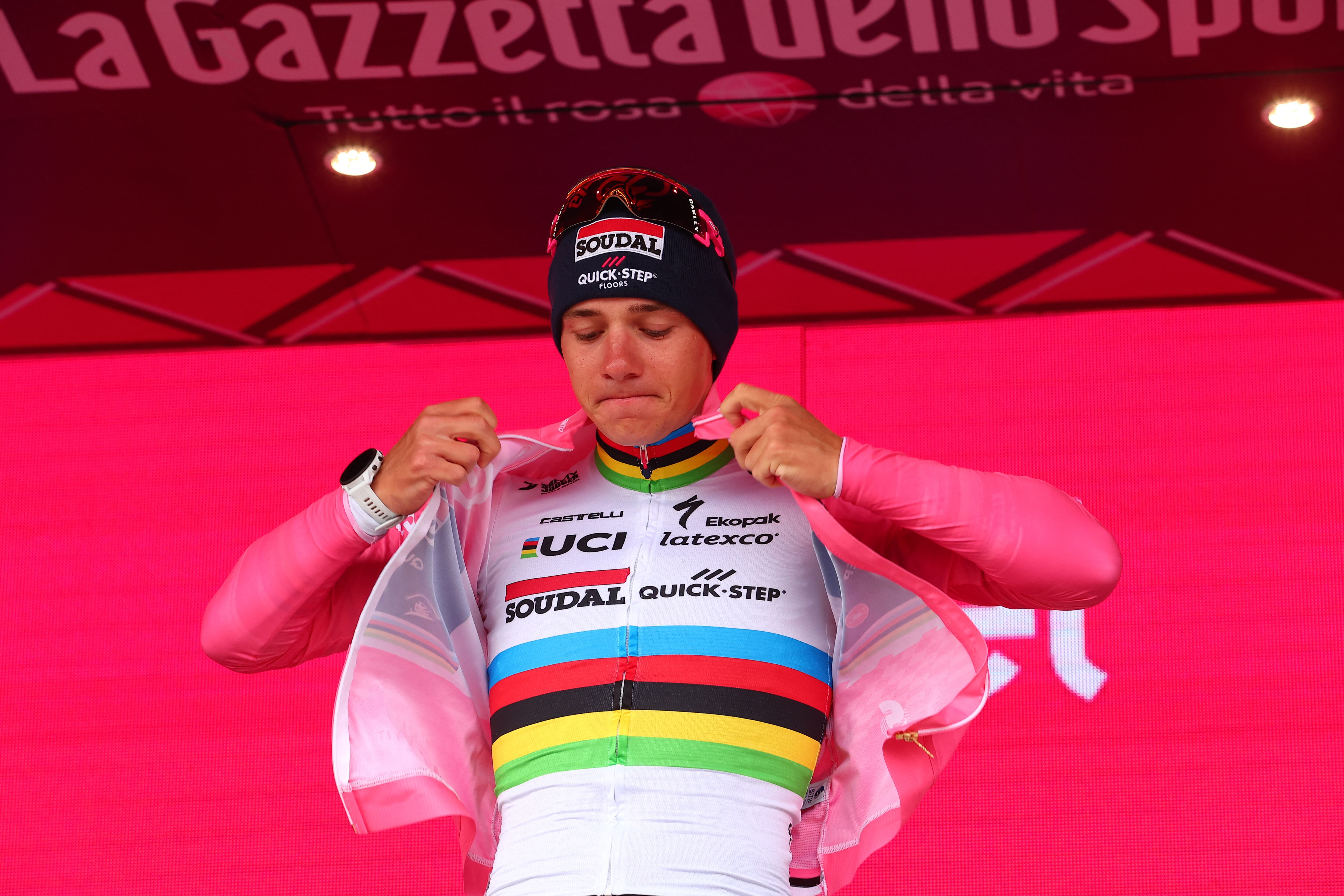 Soudal - Quick Step's Belgian rider Remco Evenepoel celebrates his overall leader's pink jersey on the podium after winning the ninth stage of the Giro d'Italia 2023 cycling race, a 35 km individual time trial between Savignano sul Rubicone and Cesena, on May 14, 2023. (Photo by Luca Bettini / AFP)