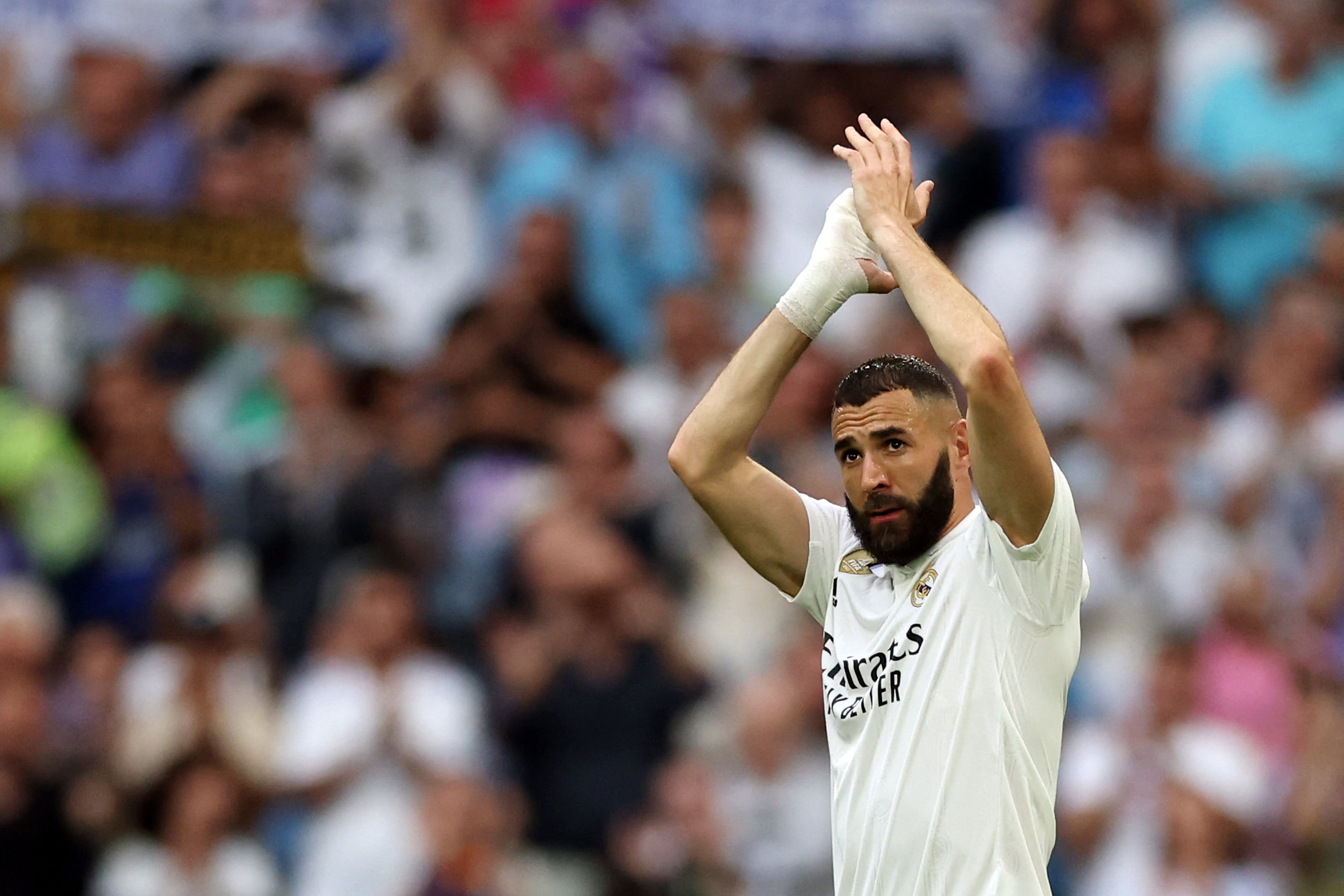 (FILES) Real Madrid's French forward Karim Benzema applauds as he is substituted during the Spanish league football match between Real Madrid CF and Athletic Club Bilbao at the Santiago Bernabeu stadium in Madrid on June 4, 2023. Real Madrid's Ballon d'Or winner Karim Benzema has signed to join Saudi Arabia's Al-Ittihad for three years starting next season, a source in the Jeddah-based club told AFP on June 6. (Photo by Pierre-Philippe MARCOU / AFP)