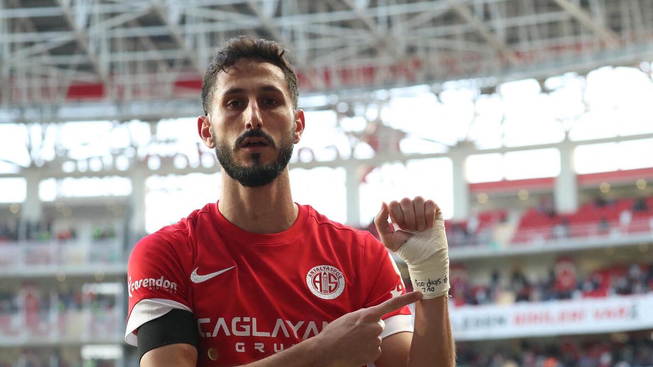 This handout photograph taken and released by Turkish news agency DHA (Demiroren News Agency) shows Antalyaspor's Israeli forward Sagiv Jehezkel displaying a bandage on his wrist reading "100 days. 07/10" after scoring a goal during Turkish Super league match between Antalyaspor and Trabzonspor at Corendon Airlines Park Antalya Stadium, in Antalya on January 14, 2024. A Turkish court on January 15, 2024, released pending trial the Israeli footballer Sagiv Jehezkel, who was detained after displaying a message referring to the Israel-Hamas war during a first division match, the DHA news agency reported. Jehezkel, 28, displayed a bandage on his wrist reading "100 days. 07/10" next to the Star of David after scoring a goal for Antalyaspor against Trabzonspor on January 14, 2024. (Photo by Handout / DHA (Demiroren News Agency) / AFP) / RESTRICTED TO EDITORIAL USE - MANDATORY CREDIT "AFP PHOTO / DHA (Demiroren News Agency) " - NO MARKETING NO ADVERTISING CAMPAIGNS - DISTRIBUTED AS A SERVICE TO CLIENTS
