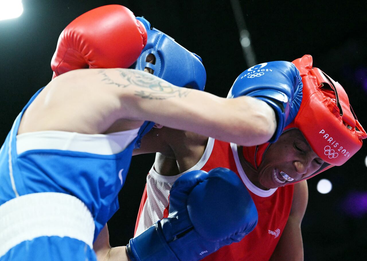 Kazakhstan's Nazym Kyzaibay (L) fights against Colombia's Ingrit Lorena Valencia Victoria during the women's 50kg quarter-final boxing match during the Paris 2024 Olympic Games at the North Paris Arena, in Villepinte on August 3, 2024. (Photo by MOHD RASFAN / AFP)
