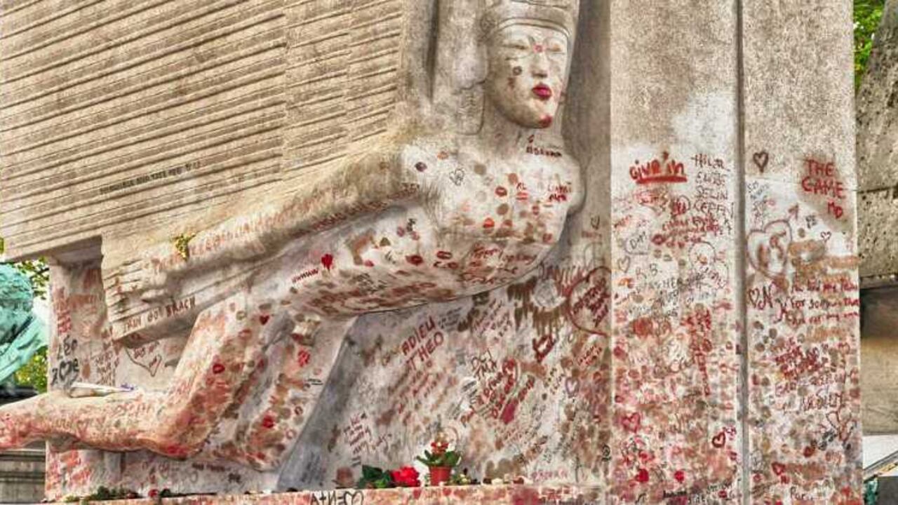 La tumba de Oscar Wilde en el cementerio Père-Lachaise de París. Es costumbre que los visitantes le dejen un beso, pero el desgaste de la piedra fue tal que en la actualidad se encuentra detrás de una barrera de plástico.