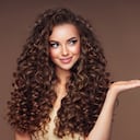 Beautiful woman with voluminous curly hairstyle