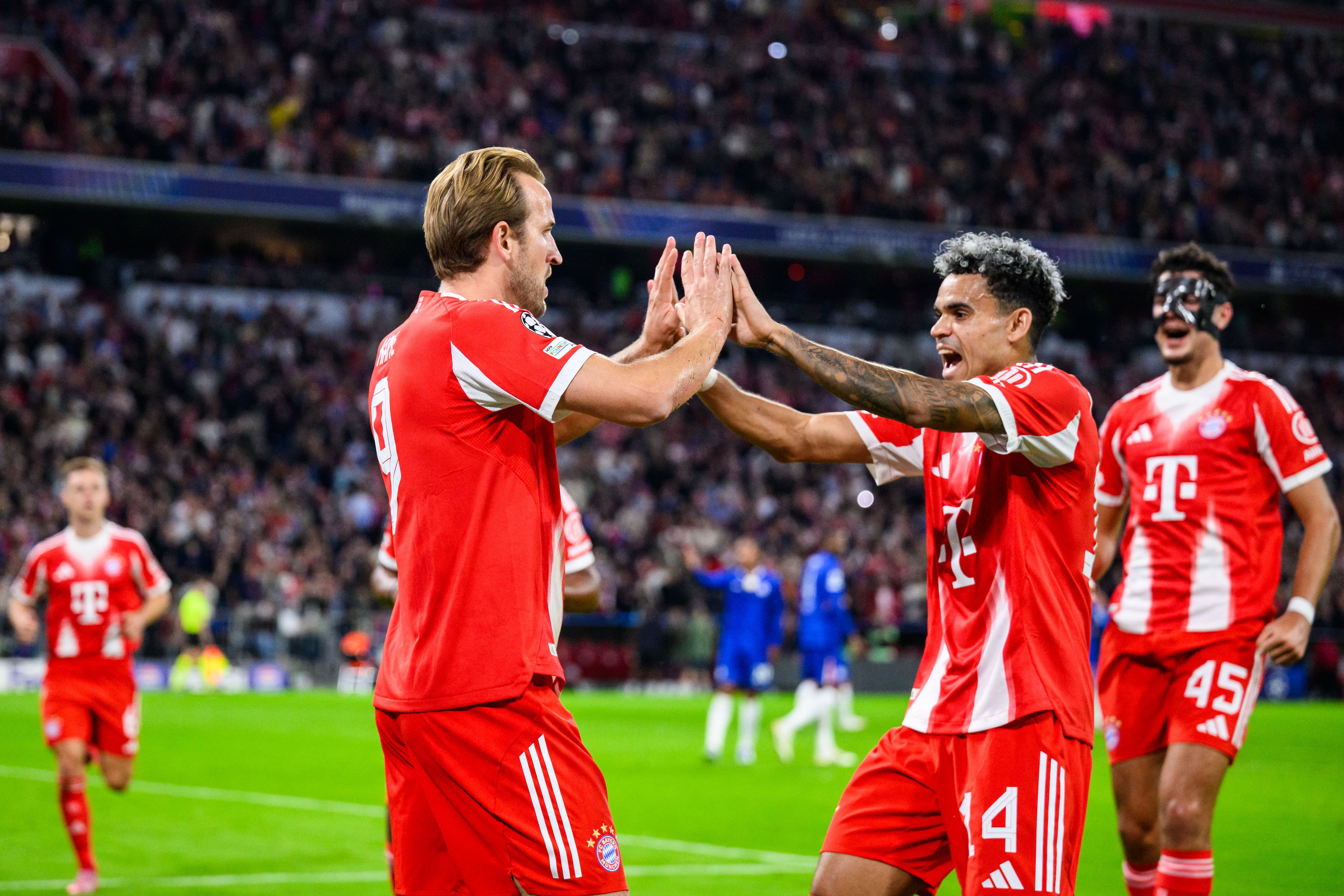 17 September 2025, Bavaria, Munich: Soccer: Champions League, Bayern Munich - Chelsea FC, preliminary round, matchday 1, Allianz Arena. Harry Kane (Bayern Munich) celebrates after his goal for 2:0 with Luis Díaz (2nd from right, Bayern Munich) and Aleksandar Pavlovi (right, Bayern Munich). Photo: Tom Weller/dpa (Photo by Tom Weller/picture alliance via Getty Images)