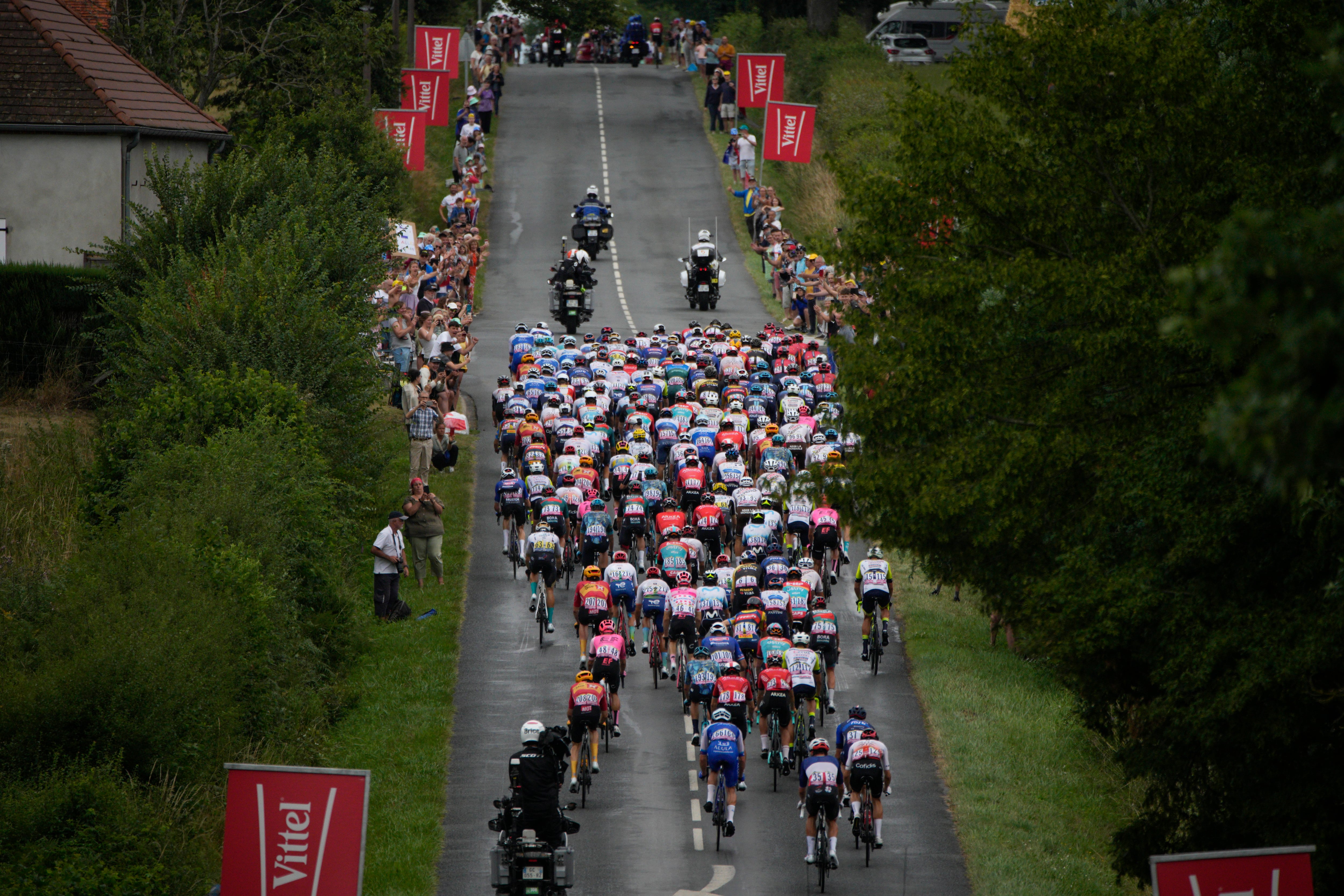 The pack rides during the eleventh stage of the Tour de France cycling race over 180 kilometers (112 miles) with start in Clermont-Ferrand and finish in Moulins, France, Wednesday, July 12, 2023. (AP Photo/Daniel Cole)l