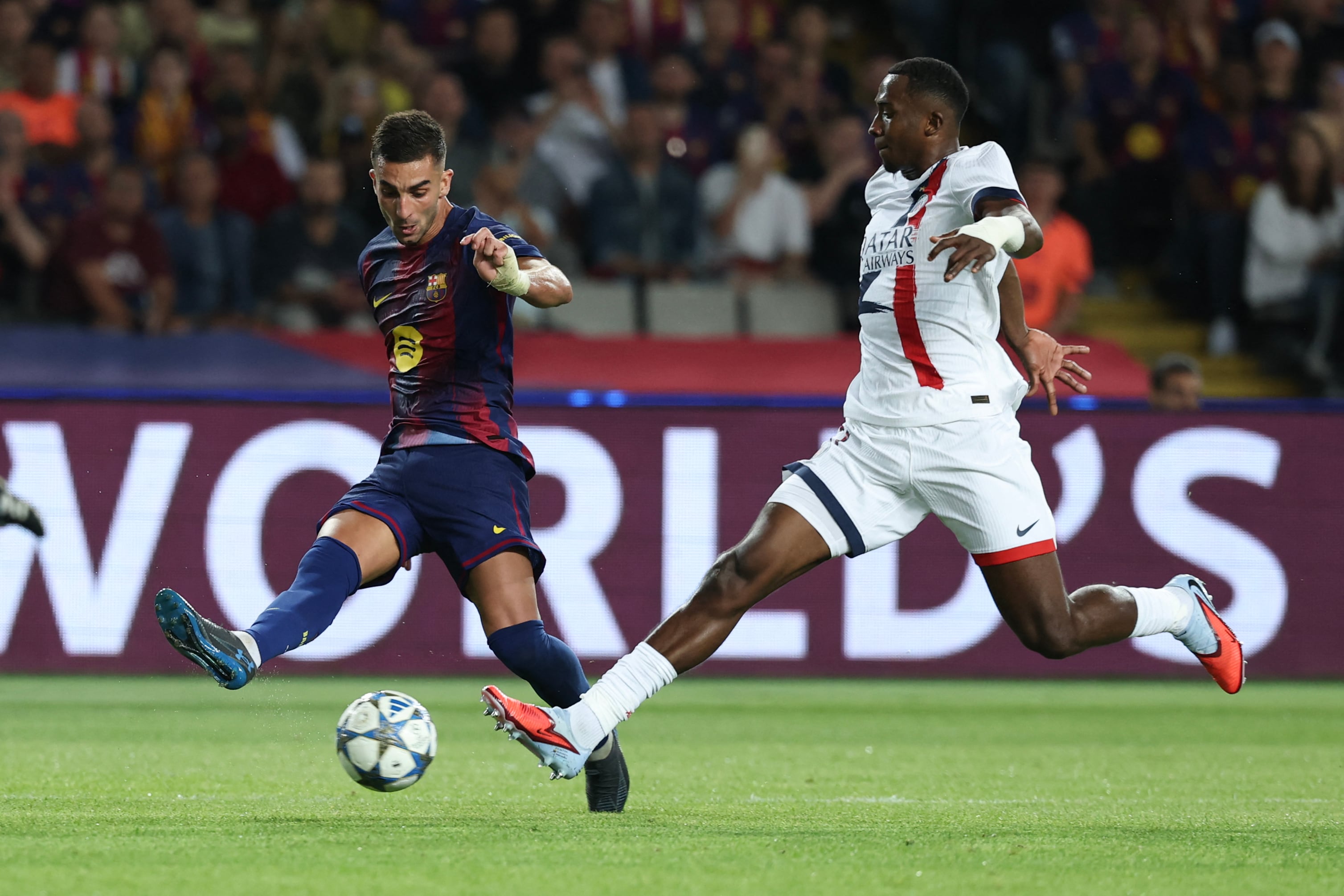 Barcelona's Spanish forward #07 Ferran Torres (L) vies for the ball with Paris Saint-Germain's Ecuadorian defender #51 William Pacho during the UEFA Champions League league phase day 2 football match between FC Barcelona and Paris Saint-Germain (PSG) at the Estadi Olimpic Lluis Companys in Barcelona, on October 1, 2025. (Photo by Lluis GENE / AFP)