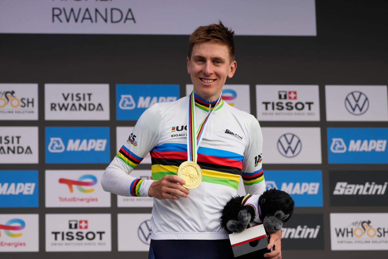 Slovenia's Tadej Pogacar shows his gold medal after winning the men's Elite road race, at the road cycling World Championships in Kigali, Rwanda, Sunday, Sept. 28, 2025. (AP Photo/Jerome Delay)