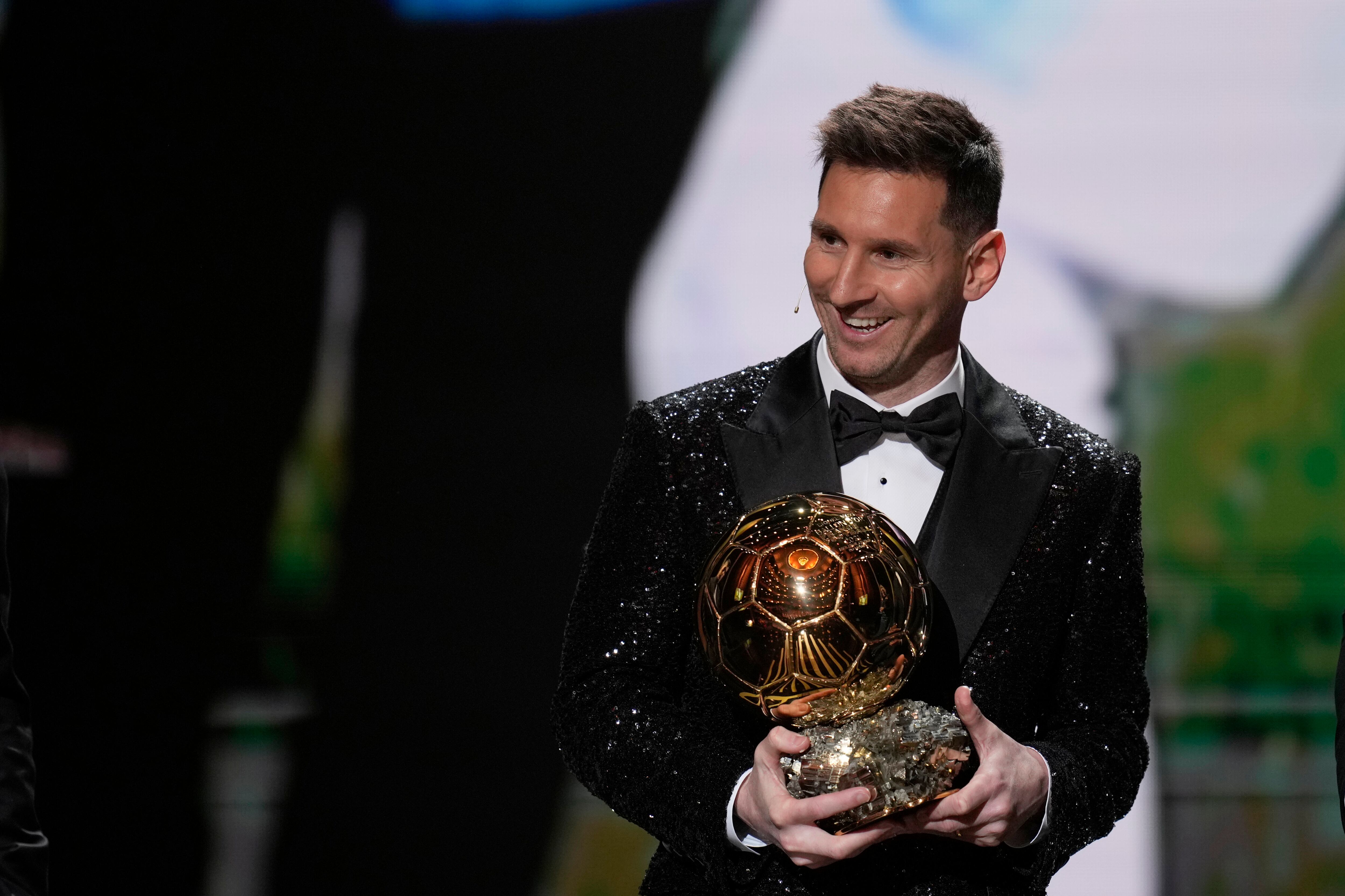 PSG player Lionel Messi reacts after winning the 2021 Ballon d'Or trophy during the 65th Ballon d'Or ceremony at Theatre du Chatelet, in Paris, Monday, Nov. 29, 2021. Messi won the Ballon d'Or for seventh time. (AP Photo/Christophe Ena)