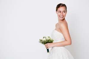 Happy bride about to throw bouquet, studio
