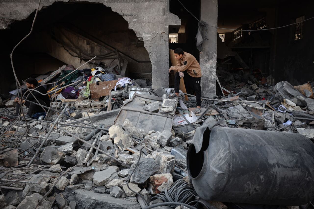 People look through the rubble in a house after an Israeli strike in Gaza City on March 18, 2025. Israel on March 18 unleashed its most intense campaign on the Gaza Strip since a January ceasefire, with Gaza civil defence agency saying 220 people killed, prompting Hamas to accuse Benjamin Netanyahu's government of torpedoing the truce. (Photo by Majdi Fathi/NurPhoto via Getty Images)
