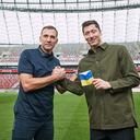 WARSAW, POLAND - SEPTEMBER 20: Poland captain Robert Lewandowski receives a Ukraine armband from Laureus Ambassador Andriy Shevchenko and pledges to carry it to FIFA World Cup 2022 Qatar at PGE Narodowy Stadium on September 20, 2022 in Warsaw, Poland. (Photo by Joosep Martinson/Getty Images for Laureus)