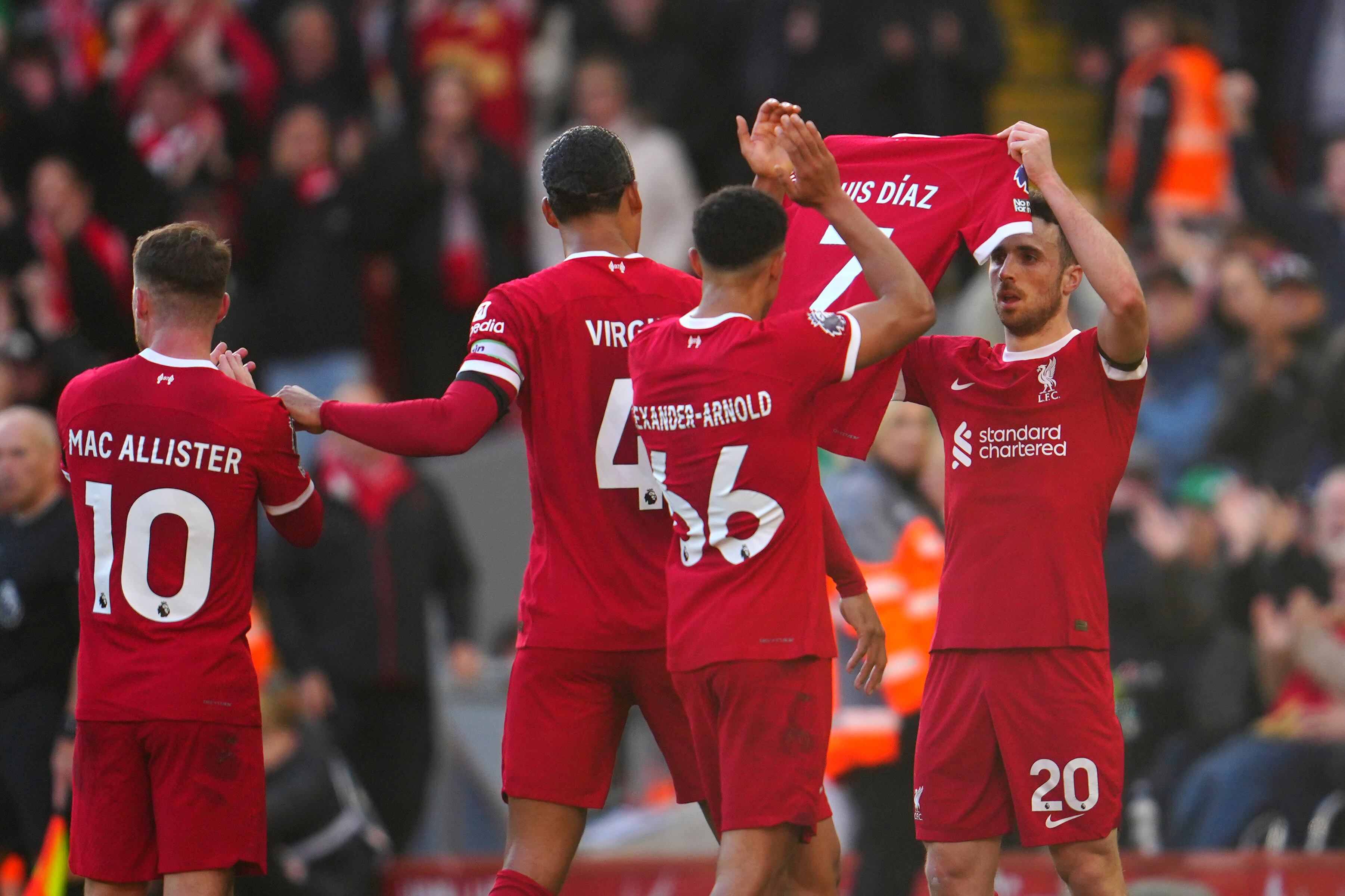 Liverpool's Diogo Jota celebrates after scoring his side's opening goal holding the jersey of teammate Luis Diaz during the English Premier League soccer match between Liverpool and Nottingham Forest, at Anfield in Liverpool, England, Sunday, Oct. 29, 2023. (AP Photo/Jon Super)
