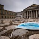 A blue mouth-nose protector lies on the pavement in front of the Bavarian State Opera in the centre of the city of Munich, Germany, during the lockdown on Tuesday, Jan. 5, 2020. (Peter Kneffel/dpa via AP)