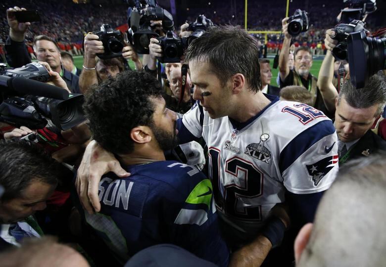 New England Patriots quarterback Tom Brady (12) greets Seattle Seahawks quarterback Russell Wilson (3) after Super Bowl XLIX. REUTERS/Mark J. Rebilas-USA TODAY Sports
