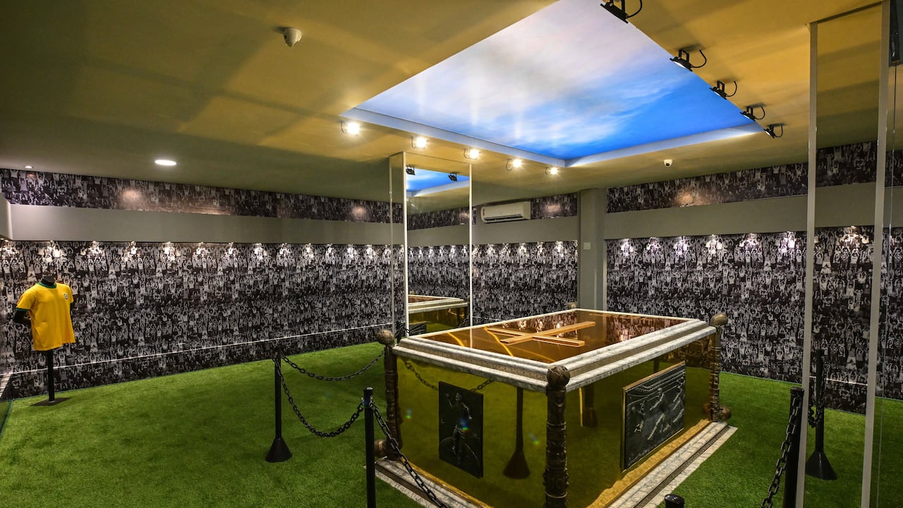 View of the mausoleum where the coffin of late Brazilian football star Pele rests, at the Ecumenical Necropolis Memorial cemetery in Santos, Brazil on May 15, 2023. In the 200 m� space, which was opened for visitation today, the public will be able to see a simulation of Santos' fans on the walls, the floor with synthetic grass and a bluish ceiling above the tomb, which is golden and has images of remarkable moments of the career of the Athlete of the Century, who died at the age of 82 on December 29, 2022. (Photo by NELSON ALMEIDA / AFP)