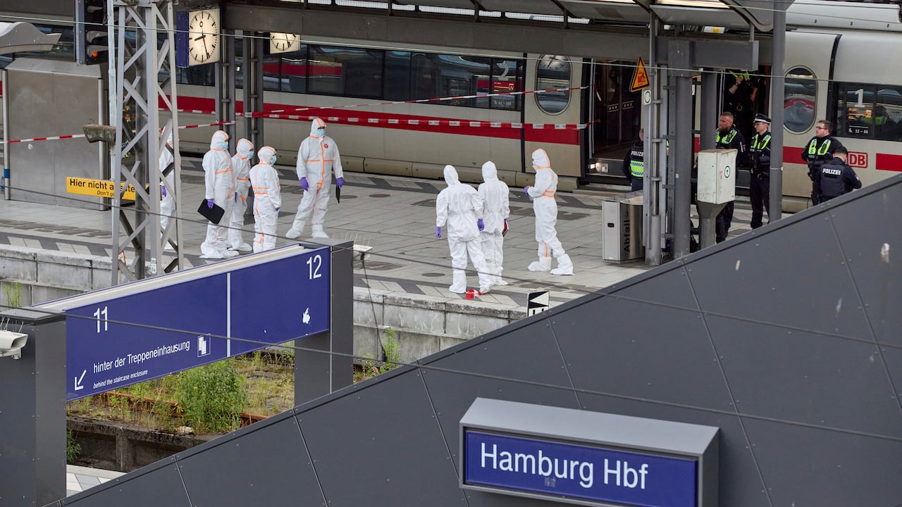 Police and forensics on duty near the scene of a stabbing at Hamburg Central Station in Hamburg, Germany, Friday, May 23, 2025. (Georg Wendt/dpa via AP)