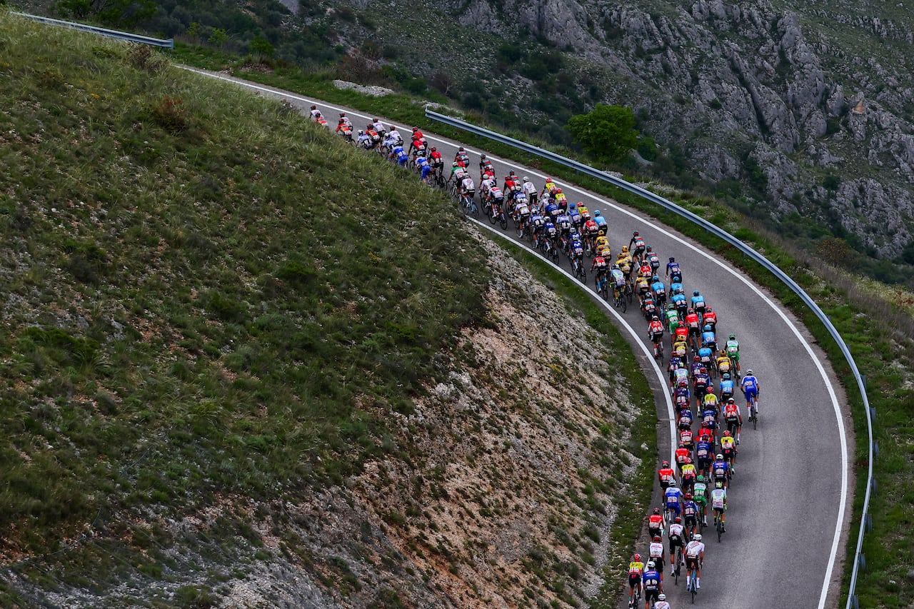 The pack of riders cycles in the final ascent to Calascio in the Apennine mountains during the seventh stage of the Giro d'Italia 2023 cycling race, 218 km between Capua and Gran Sasso d'Italia, on May 12, 2023. (Photo by Luca Bettini / AFP)