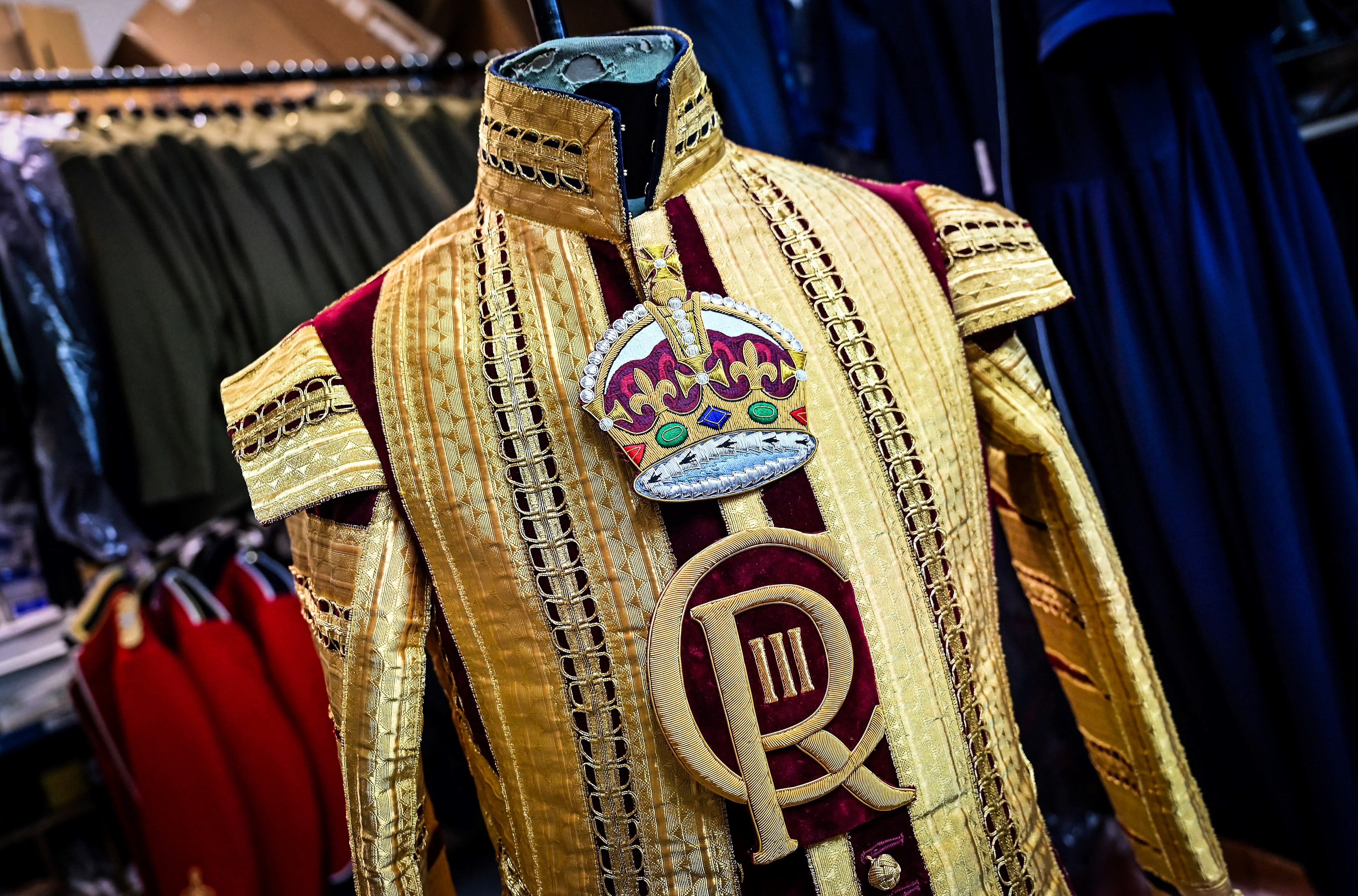 A Drum Major's State coat adorned with the new CR III cypher and to be worn during the Coronation of Britain's King Charles III and his wife Britain's Camilla, Queen Consort is pictured at Kashket & Partners atelier, in north London, on May 5, 2023. (Photo by Justin TALLIS / AFP)