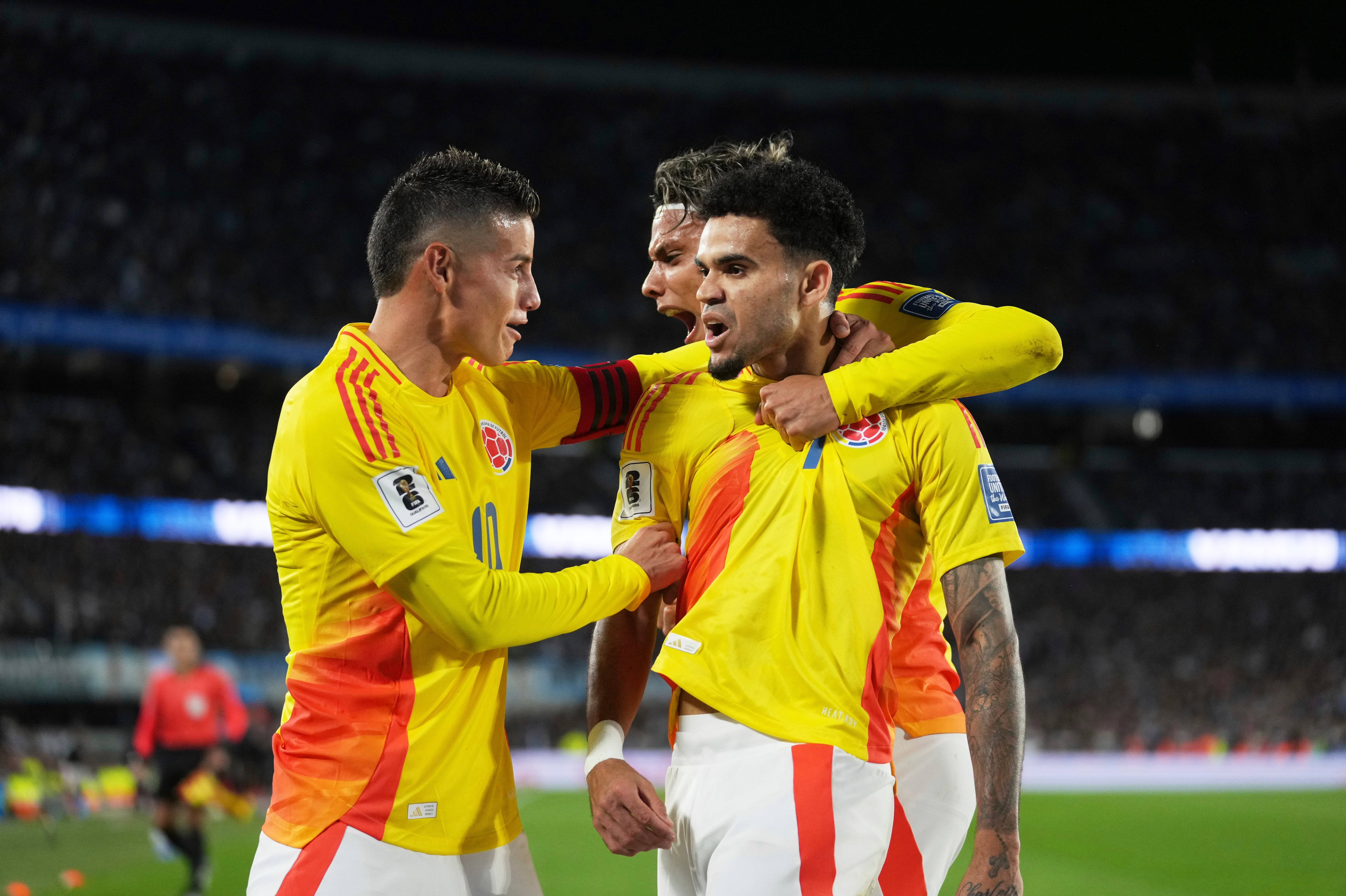 Colombia's Luis Diaz, right, is congratulated after scoring his side's opening goal against Argentina during a qualifying soccer match for the FIFA World Cup 2026 at the Monumental stadium in Buenos Aires, Argentina, Tuesday, June 10, 2025. (AP Photo/Gustavo Garello)
