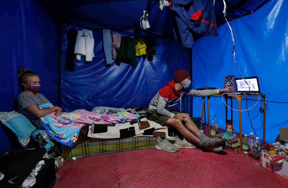 En una improvisado toldo, bajo la carpa central del circo, los bailarines rusos Ekaterina Kakina (24 años) y Ruslan Guseinov (25 años) pasan los días de cuarentena escuchando rap y cocinando lo que les llega por solidaridad. “Amo las frutas de Colombia”, dice Ruslan a través de una aplicación de traducción en su celular. Foto: Guillermo Torres SEMANA