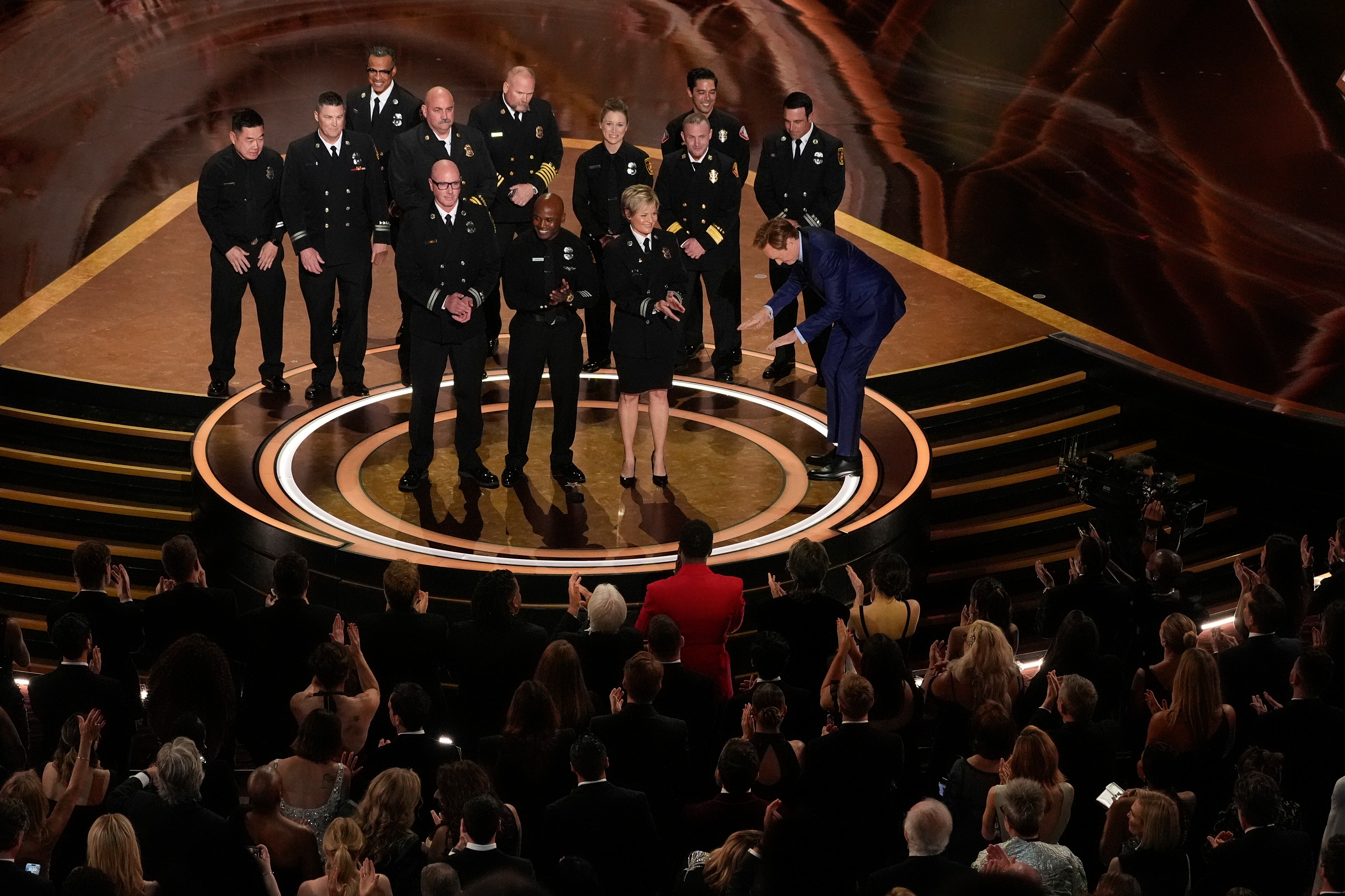 Members of the Los Angeles Fire Department and Host Conan O'Brien on stage during the Oscars on Sunday, March 2, 2025, at the Dolby Theatre in Los Angeles. (AP Photo/Chris Pizzello)