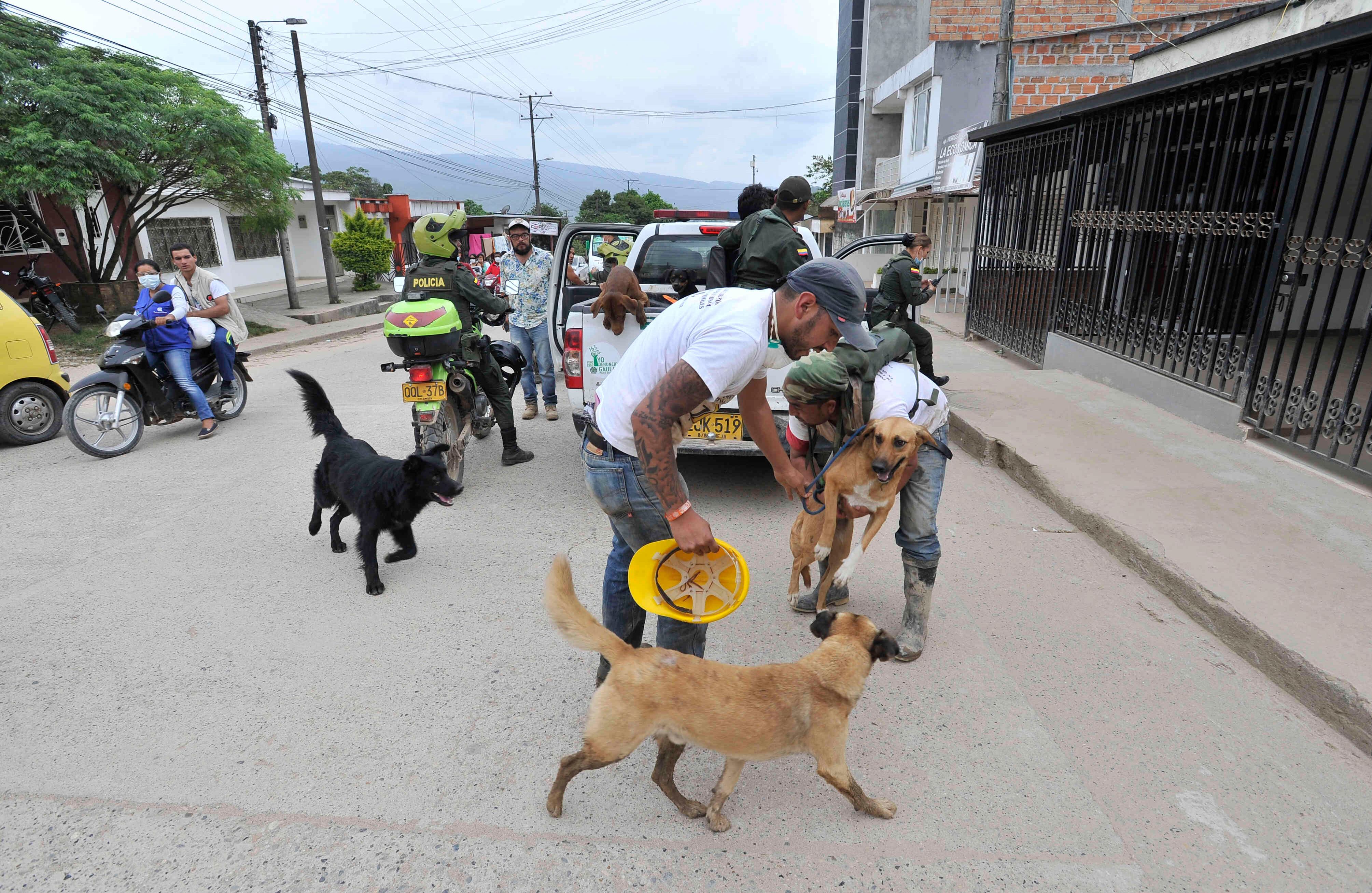 Dos miembros de la Asociación por la Defensa de los Animales, Zona Animal Pasto, se bajan de un carro de la Polcía luego de rescatar a varios perros, el miércoles 5 de abril de 2017, en un refugio provisional en Mocoa, Putumayo, luego de que una avalancha de lodo y piedra —la noche del 31 de marzo— provocada por el desbordamiento de los ríos Mocoa, Mulato y Sangoyaco, matara a por lo menos 301 personas y dejara un número indeterminado de desaparecidos. Foto: Carlos Julio Martínez / SEMANA
