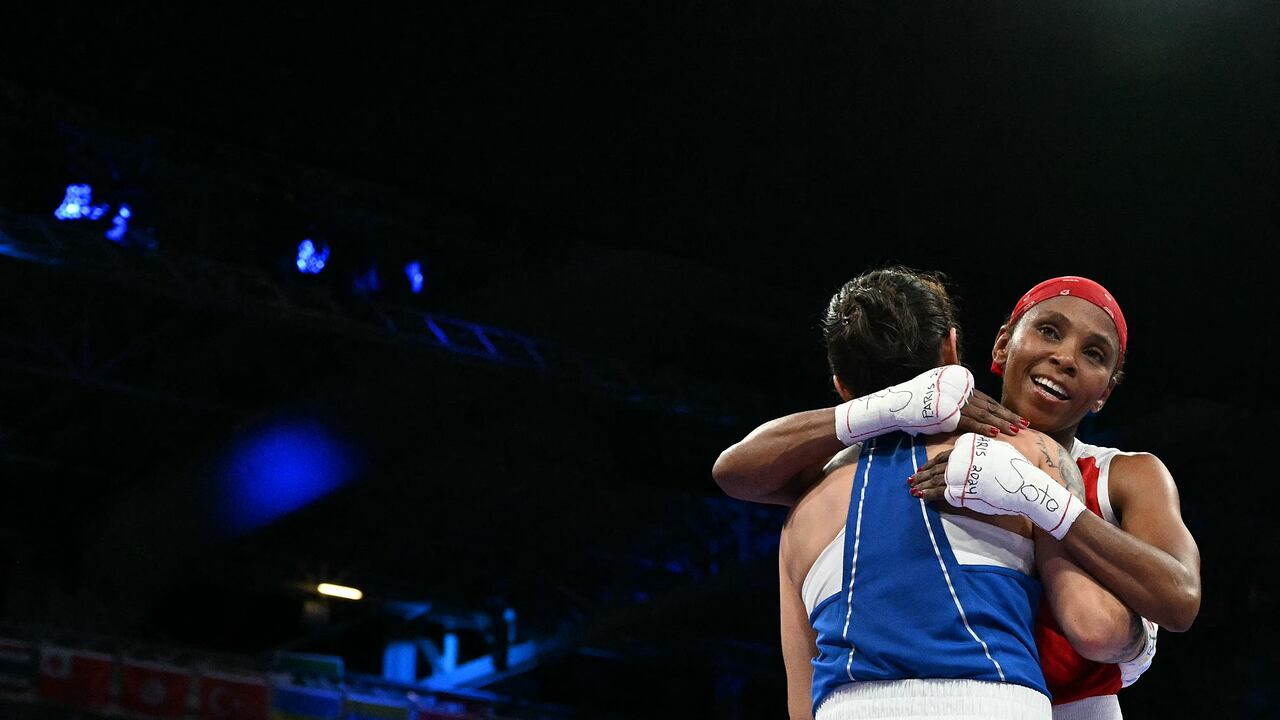 Kazakhstan's Nazym Kyzaibay (L) and Colombia's Ingrit Lorena Valencia Victoria at the end of the women's 50kg quarter-final boxing match during the Paris 2024 Olympic Games at the North Paris Arena, in Villepinte on August 3, 2024. (Photo by MOHD RASFAN / AFP)