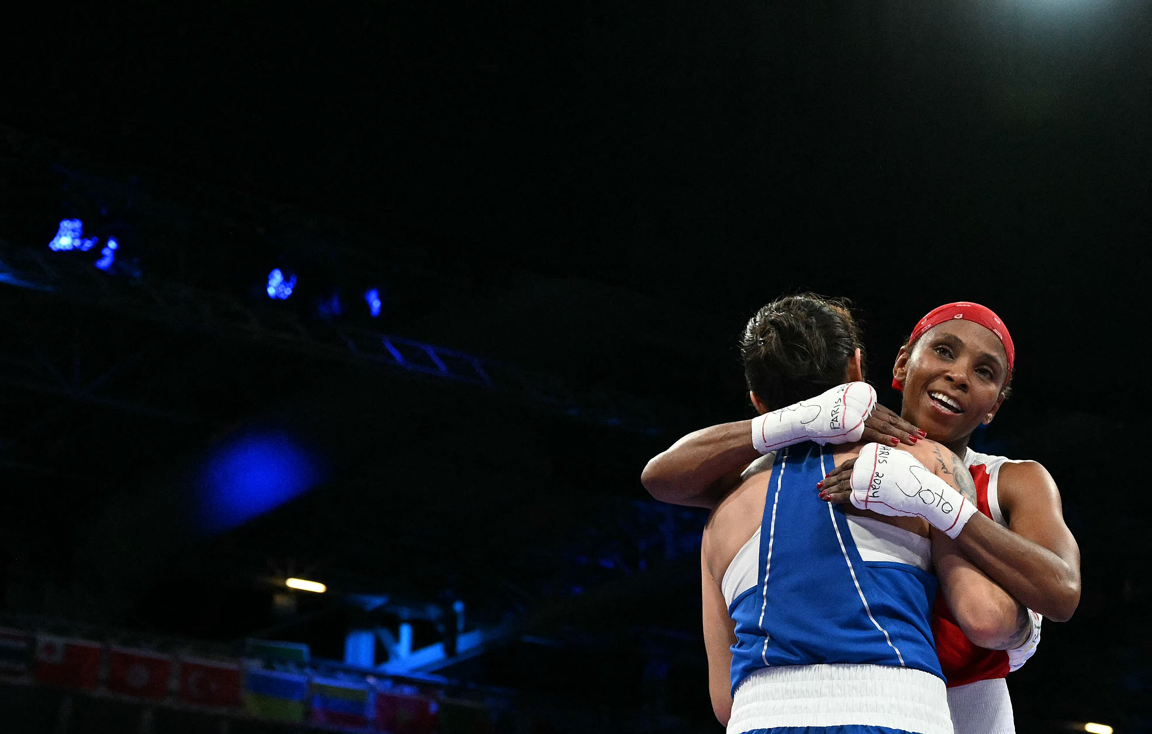 Kazakhstan's Nazym Kyzaibay (L) and Colombia's Ingrit Lorena Valencia Victoria at the end of the women's 50kg quarter-final boxing match during the Paris 2024 Olympic Games at the North Paris Arena, in Villepinte on August 3, 2024. (Photo by MOHD RASFAN / AFP)