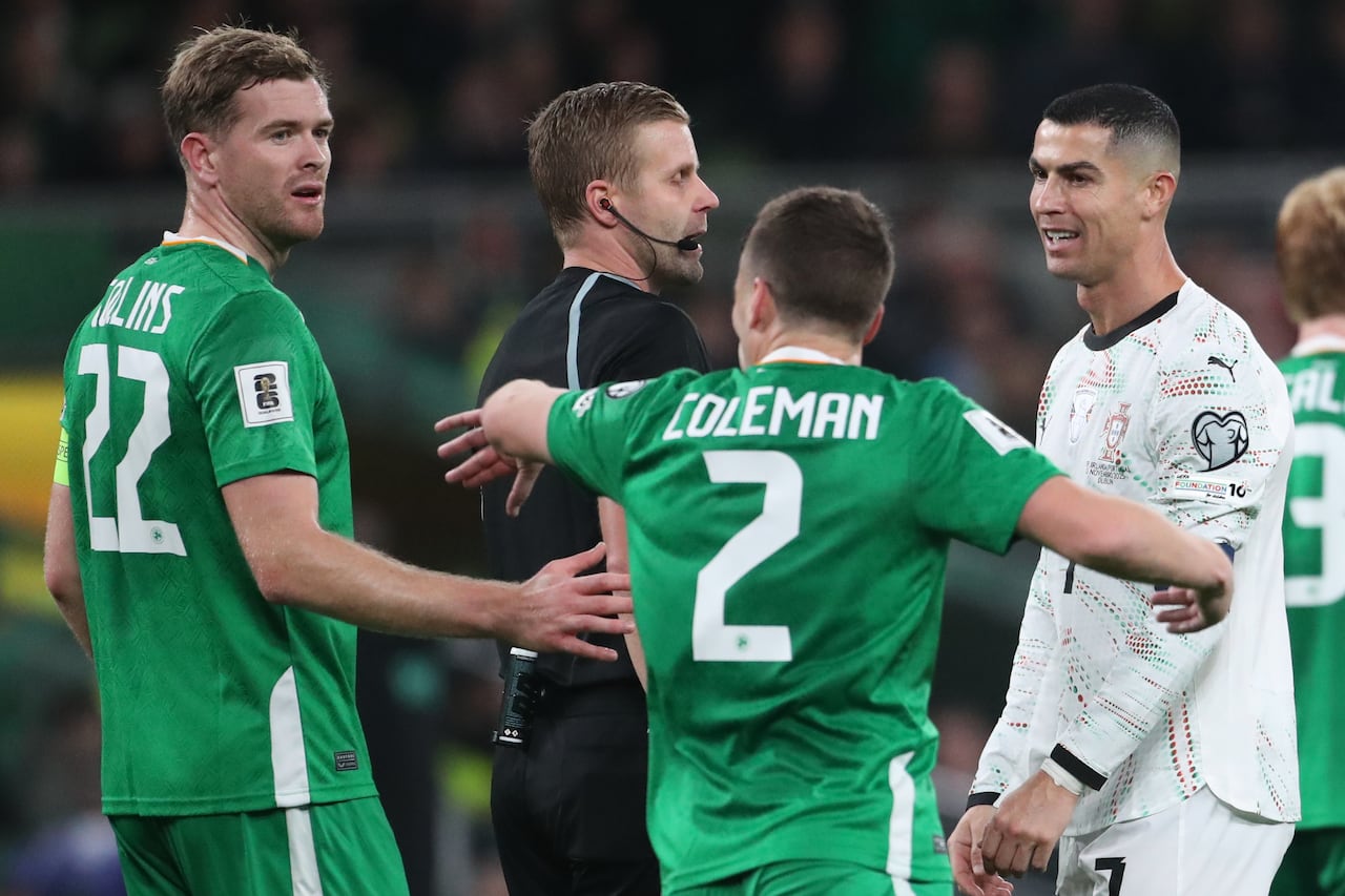 Referee Glenn Nyberg, second left, speaks with Portugal's Cristiano Ronaldo, right during a World Cup 2026 group F qualifying soccer match between Ireland and Portugal in Dublin, Thursday, Nov. 13, 2025. (AP Photo/Peter Morrison)