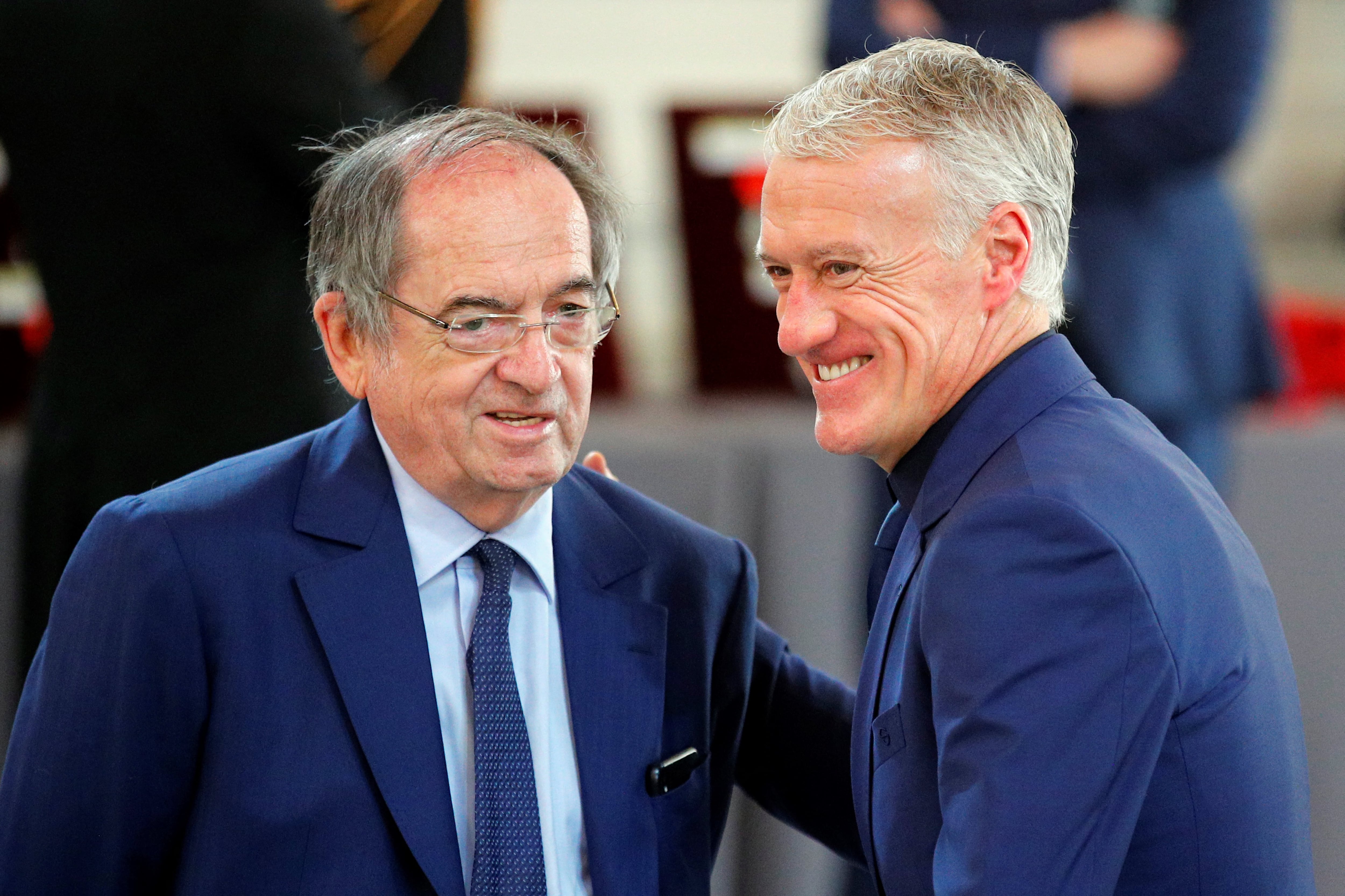 (FILES) In this file photo taken on June 4, 2019 French football Federation president Noel Le Graet (L) and  French national football team head coach Didier Deschamps share a laugh during a Legion of Honour award ceremony for French 2018 football World Cup winners at the Elysee Palace in Paris. - Didier Deschamps extends stay as France coach until 2026, he announced at the French Football Federation's general assembly in Paris on January 7, 2023. (Photo by Francois Mori / POOL / AFP)