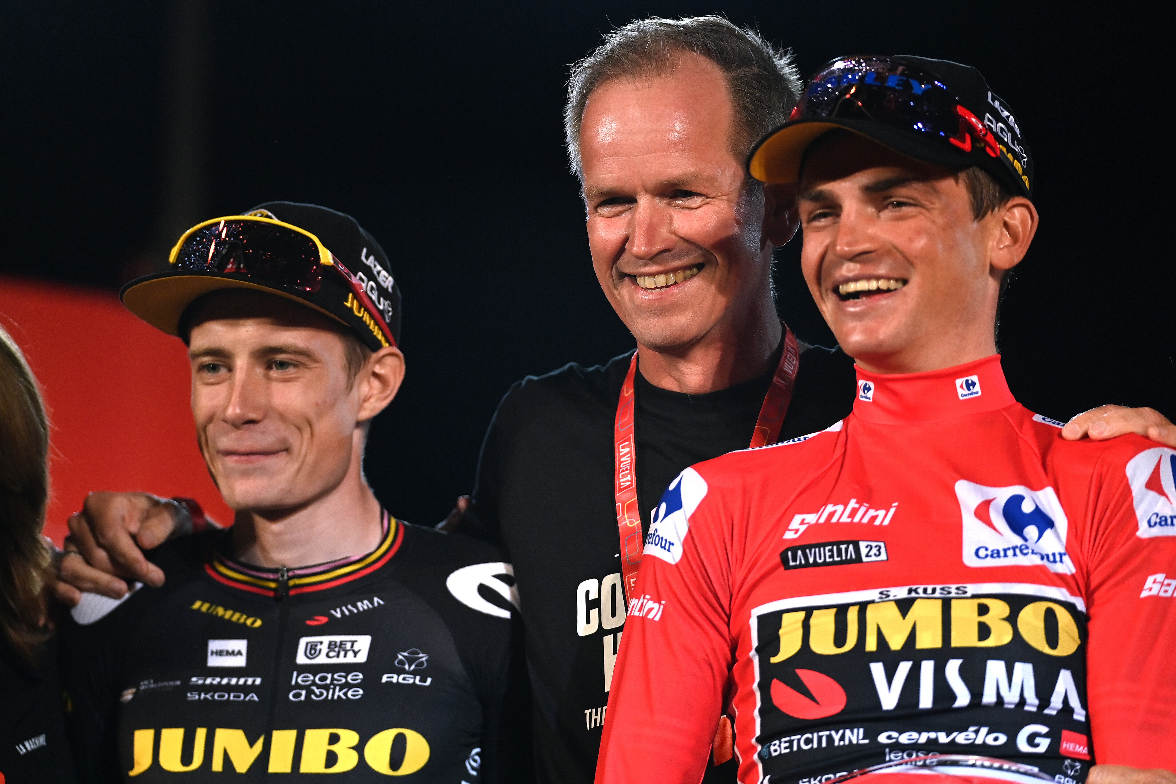 MADRID, SPAIN - SEPTEMBER 17: (L-R) Jonas Vingegaard of Denmark on second place, Team Jumbo-Visma general manager Richard Plugge of Netherlands and race winner Sepp Kuss of The United States - Red Leader Jersey pose on the podium ceremony after the 78th Tour of Spain 2023, Stage 21 a 101.5km stage from Hipódromo de la Zarzuela to Madrid. Paisaje de la Luz / #UCIWT / on September 17, 2023 in Madrid, Spain. (Photo by Tim de Waele/Getty Images)