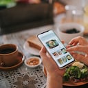 high angle view asian chinese woman's hand on mobile app for online food delivery during breakfast time