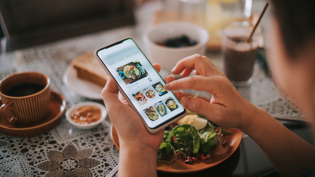 high angle view asian chinese woman's hand on mobile app for online food delivery during breakfast time