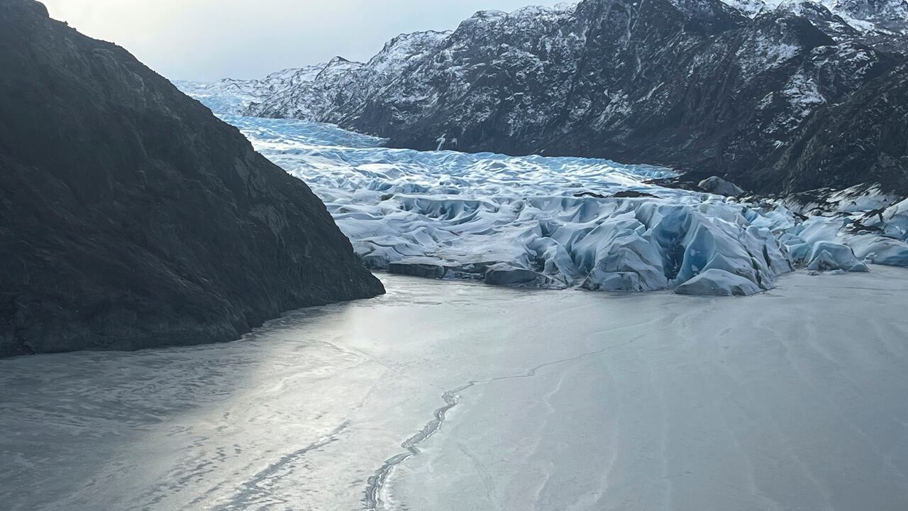 This photo provided by the Alaska National Guard shows an airplane partially submerged into the ice of Tustumena Lake at the toe of a glacier on Monday, March 24, 2025, near Soldotna, Alaska. (Alaska National Guard via AP)