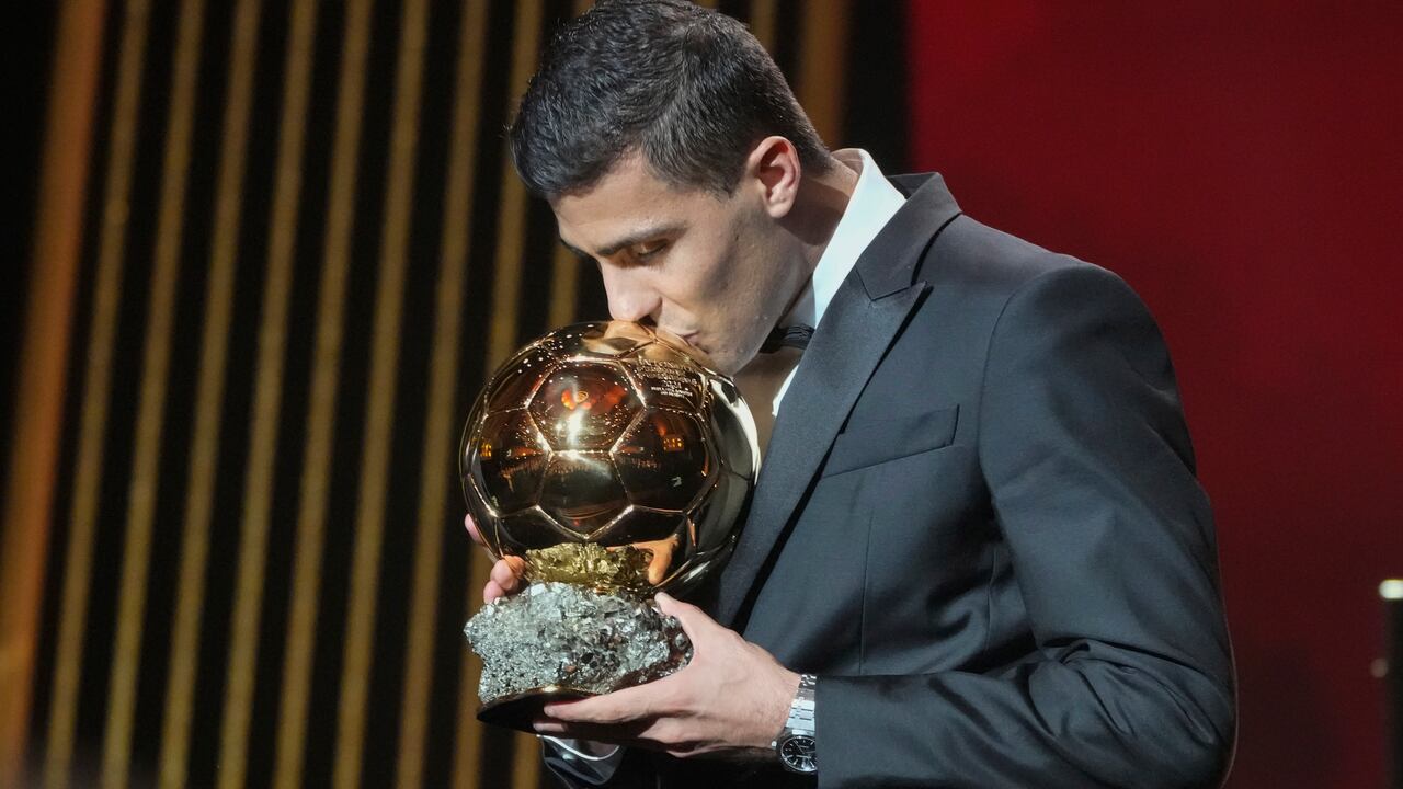 Manchester City's Spanish player Rodri kisses the trophy as he receives the 2024 Men's Ballon d'Or award during the 68th Ballon d'Or (Golden Ball) award ceremony at Theatre du Chatelet in Paris, Monday, Oct. 28, 2024. (AP Photo/Michel Euler)